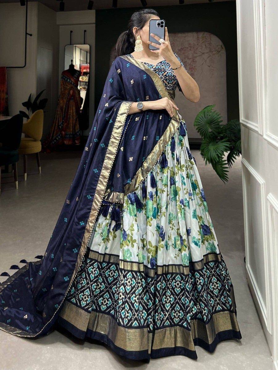 Woman in floral print lehenga choli with navy dupatta, ethnic Indian wear for weddings and parties