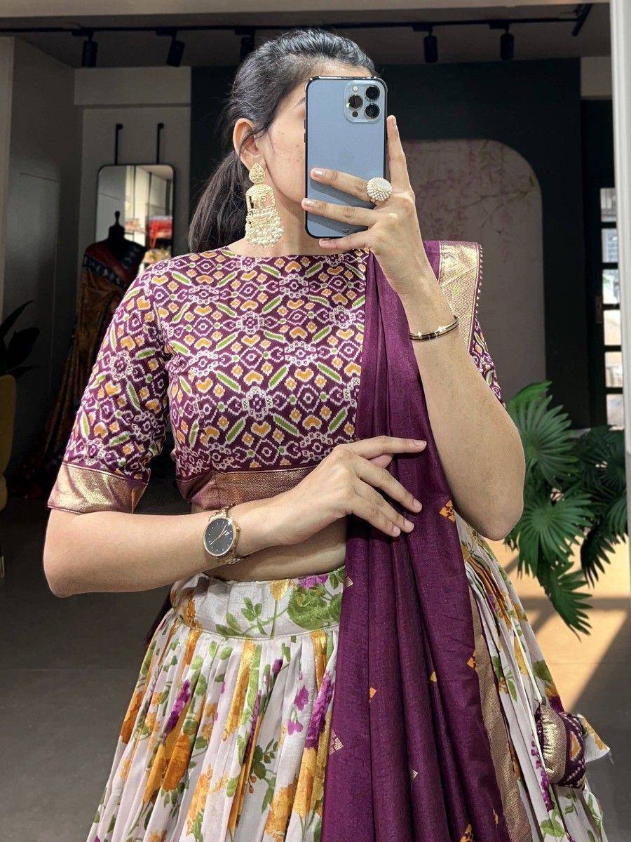 Woman in purple printed lehenga choli with floral skirt, ethnic Indian wear for festive occasions