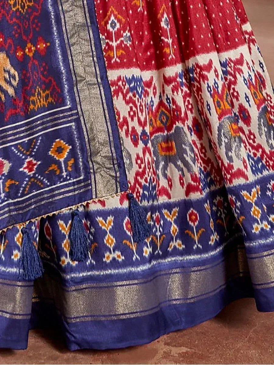 Blue and red ethnic lehenga with elephant print, tassels, and ikat patterns for Indian festive wear