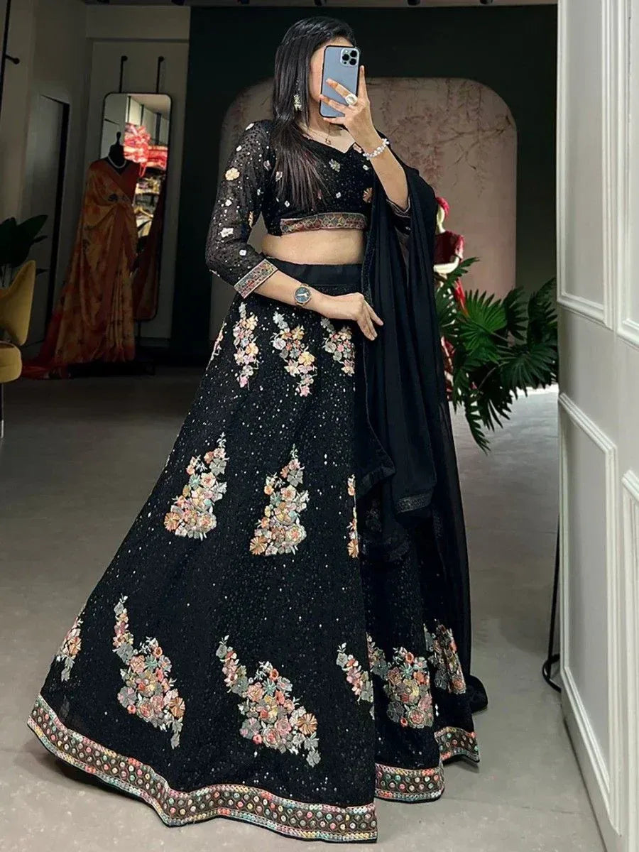 Black floral embroidered lehenga choli with sheer sleeves and dupatta, perfect for Indian ethnic occasions