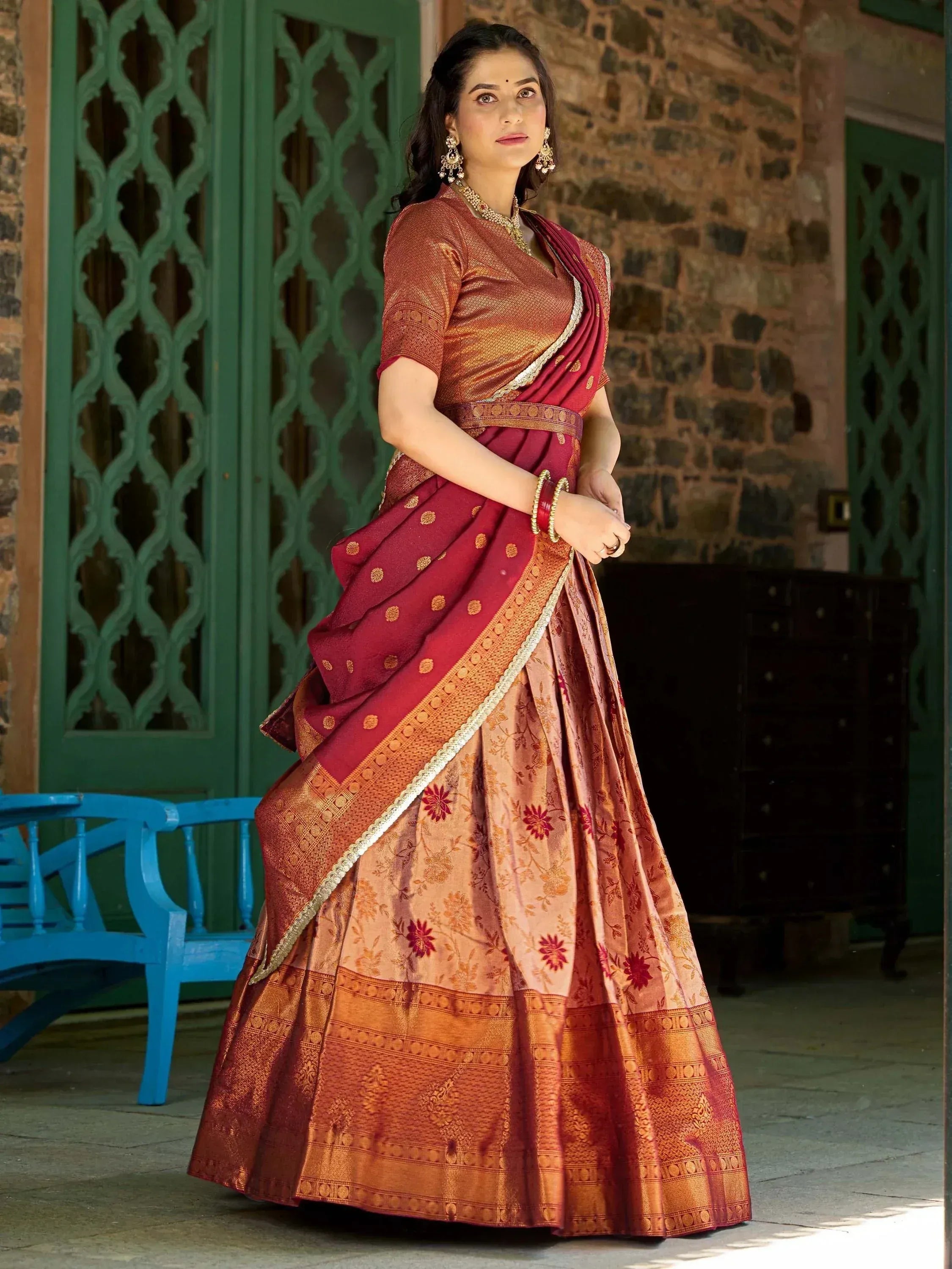 Elegant maroon and gold designer lehenga choli with floral motifs, perfect for Indian ethnic occasions.