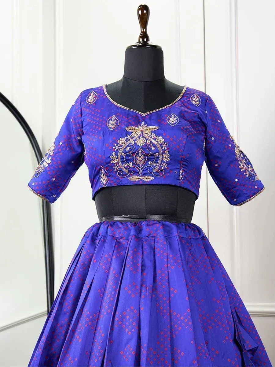 Royal blue embroidered lehenga choli with gold floral motifs and red dot pattern, perfect for Indian ethnic wear