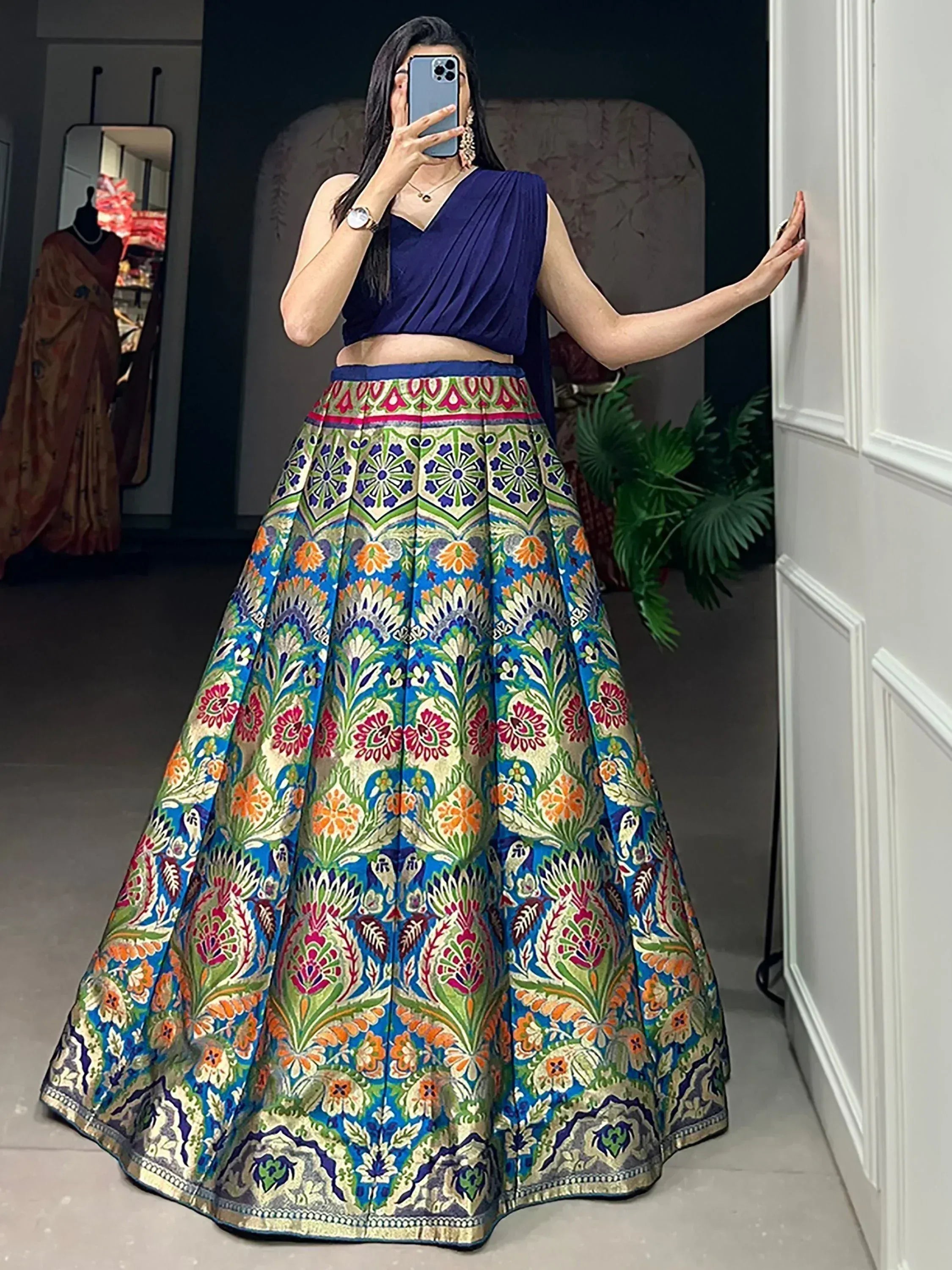 Woman in vibrant floral lehenga choli with blue crop top, perfect for Indian ethnic wear occasions
