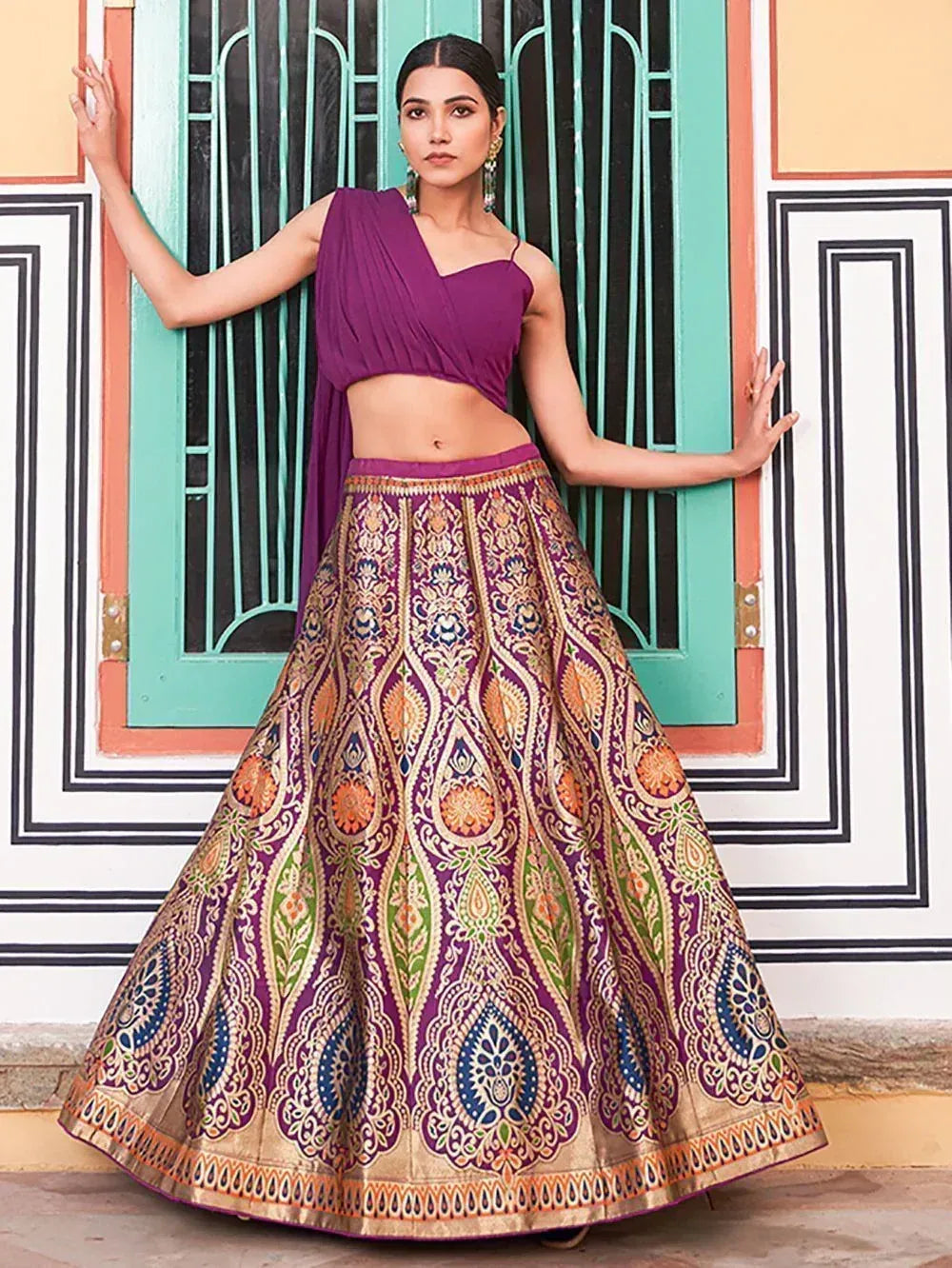 Purple designer lehenga choli with intricate gold and multicolor embroidery, perfect for Indian ethnic occasions.