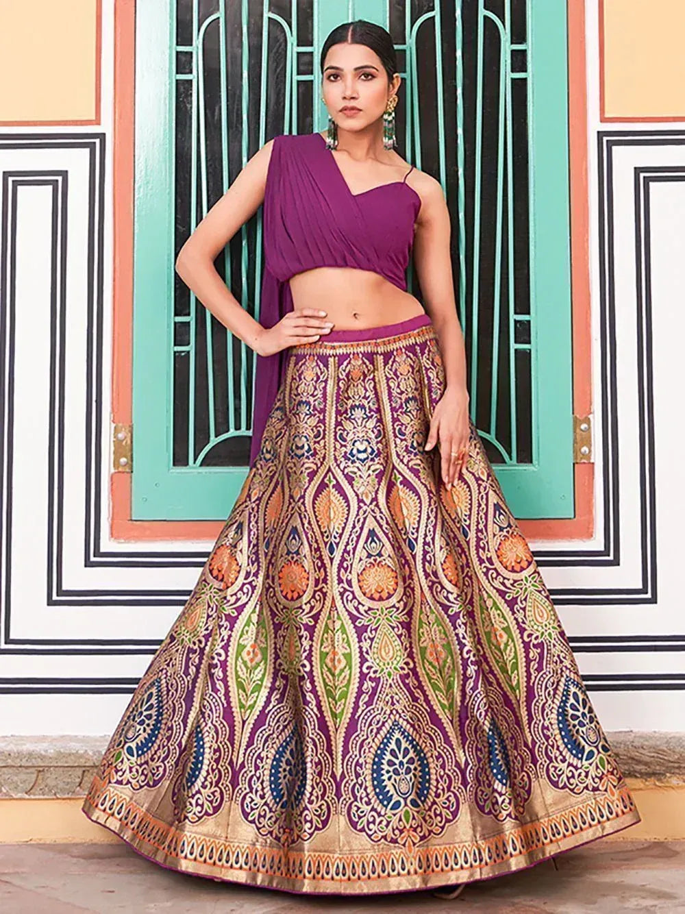 Purple designer lehenga choli with intricate gold and multicolor embroidery, perfect for Indian ethnic wear occasions.