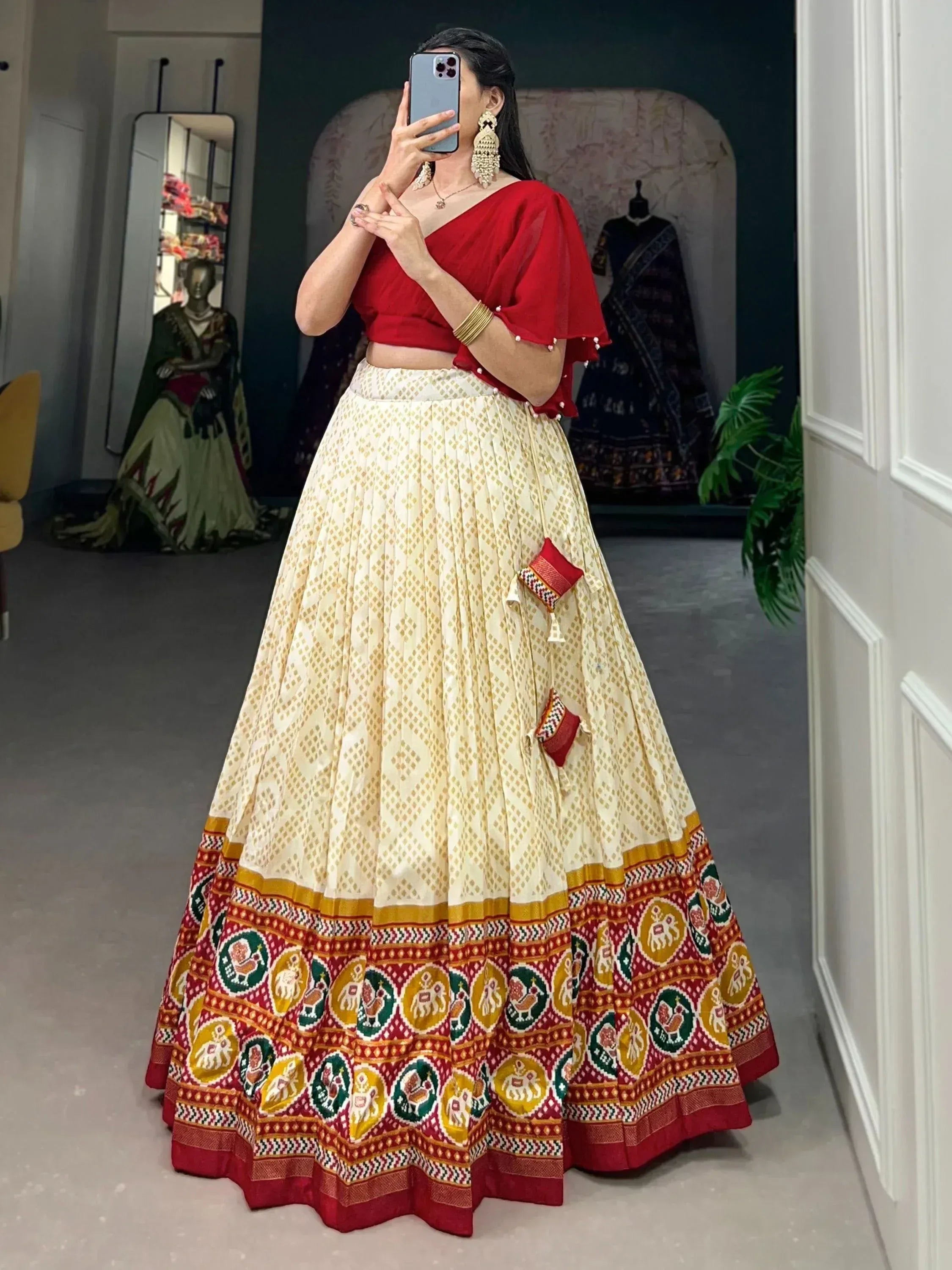 Red and cream printed lehenga choli with elephant motifs, perfect for Indian ethnic wear occasions.