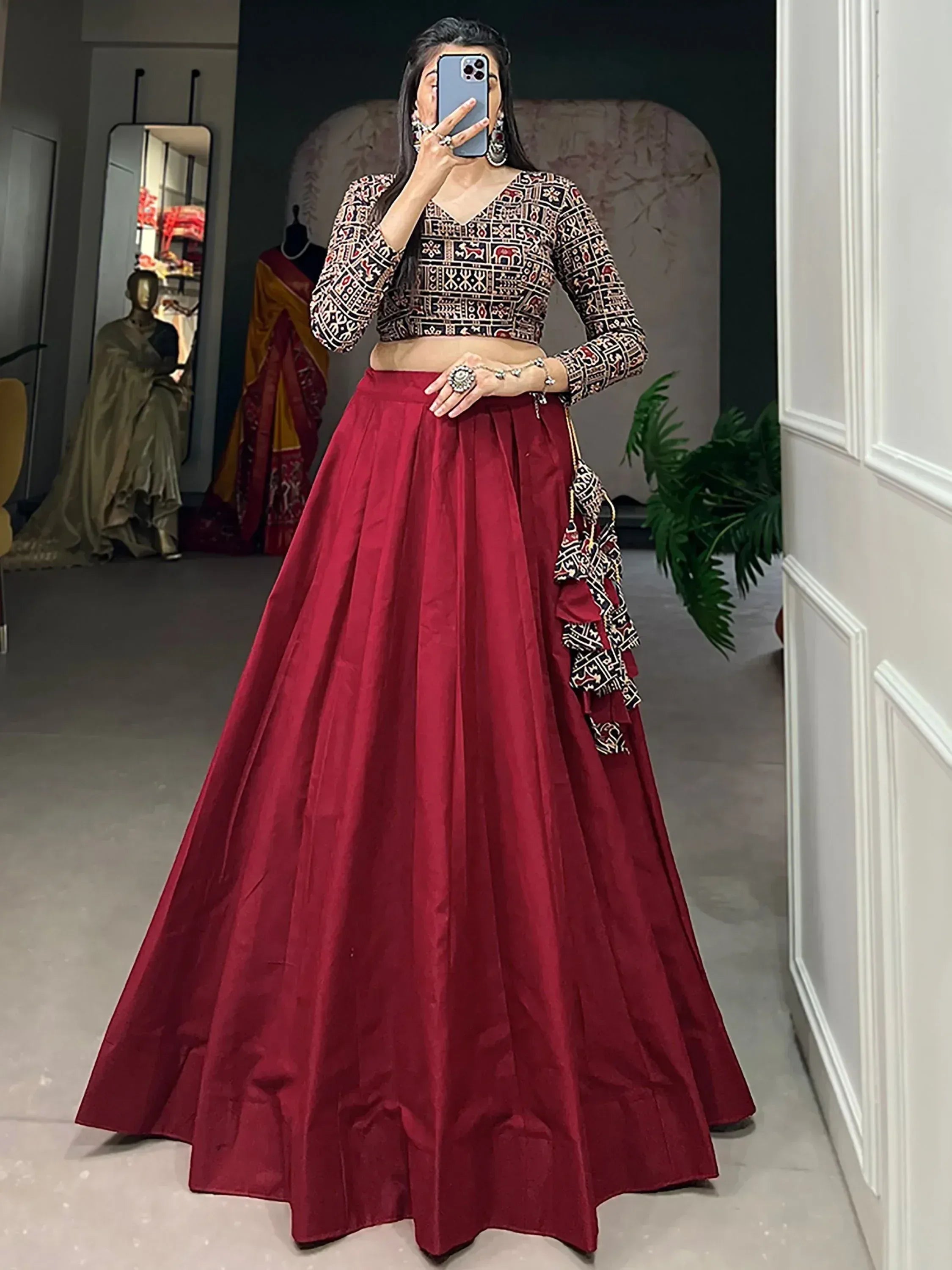Woman in maroon lehenga choli with printed blouse, ethnic Indian wear for weddings and parties