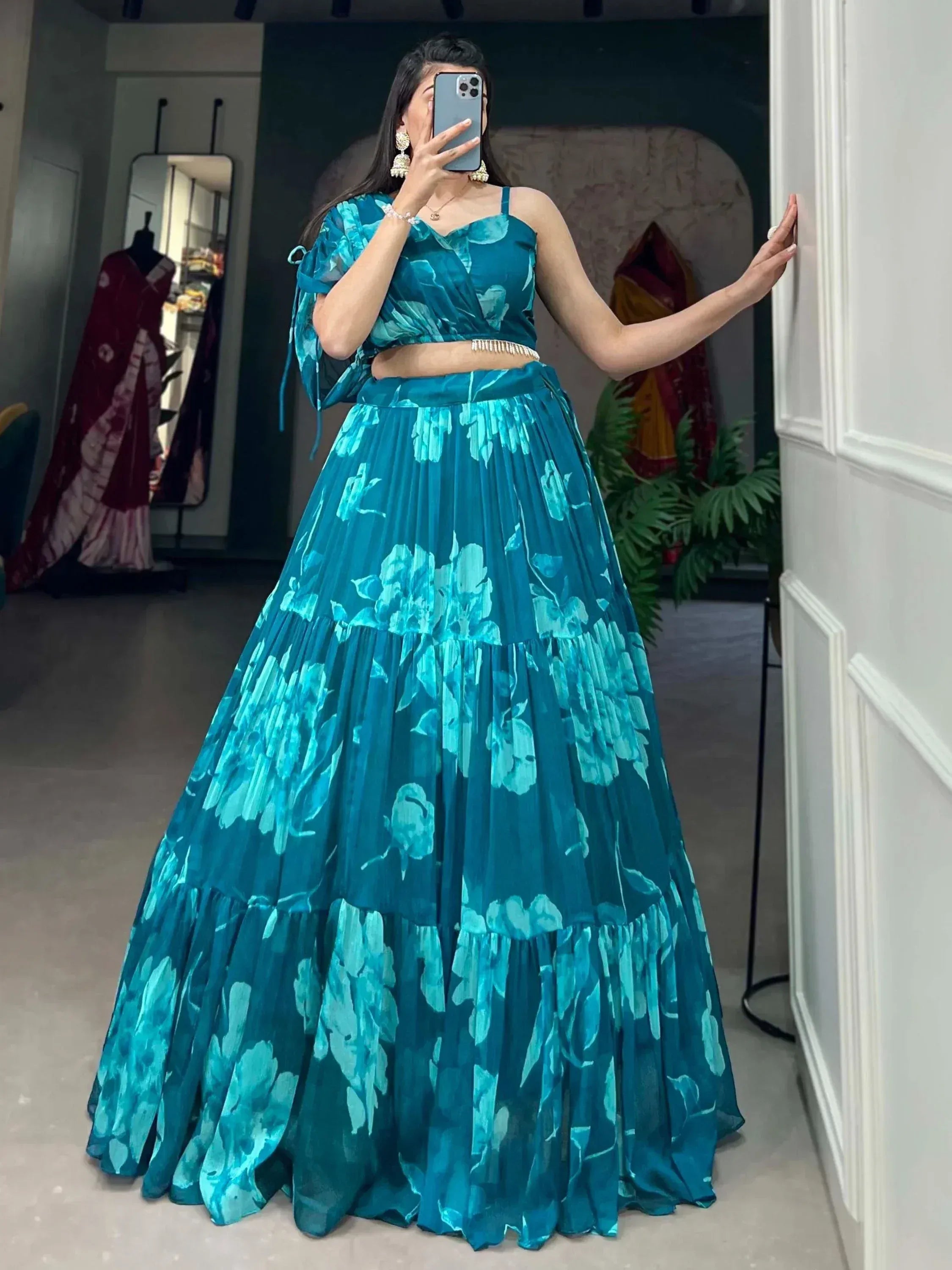 Teal floral print lehenga choli with layered skirt and crop top, perfect for Indian ethnic wear occasions