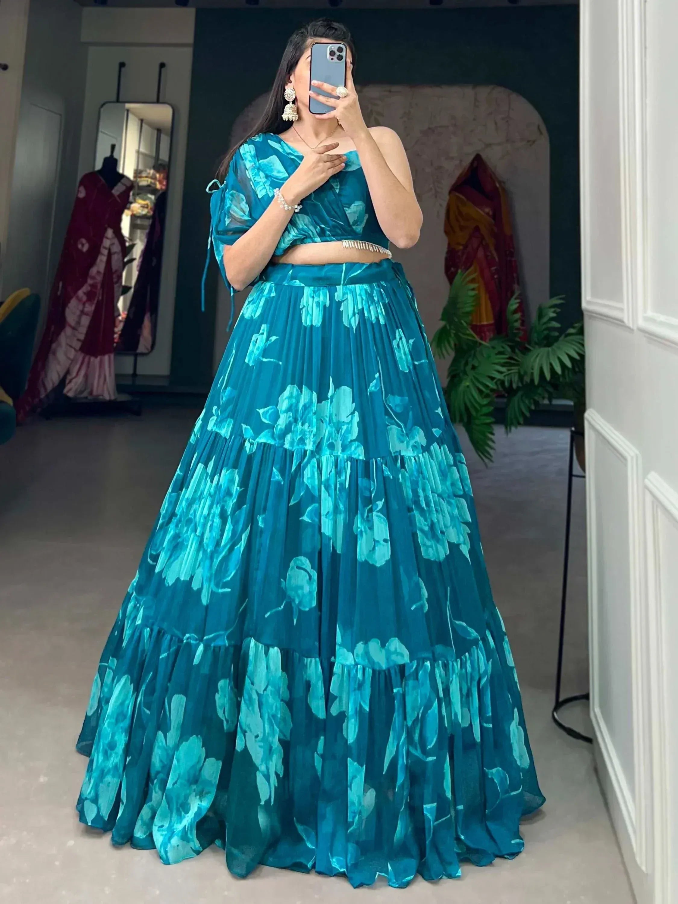 Teal floral print lehenga choli with one-shoulder top, perfect for Indian ethnic wear occasions