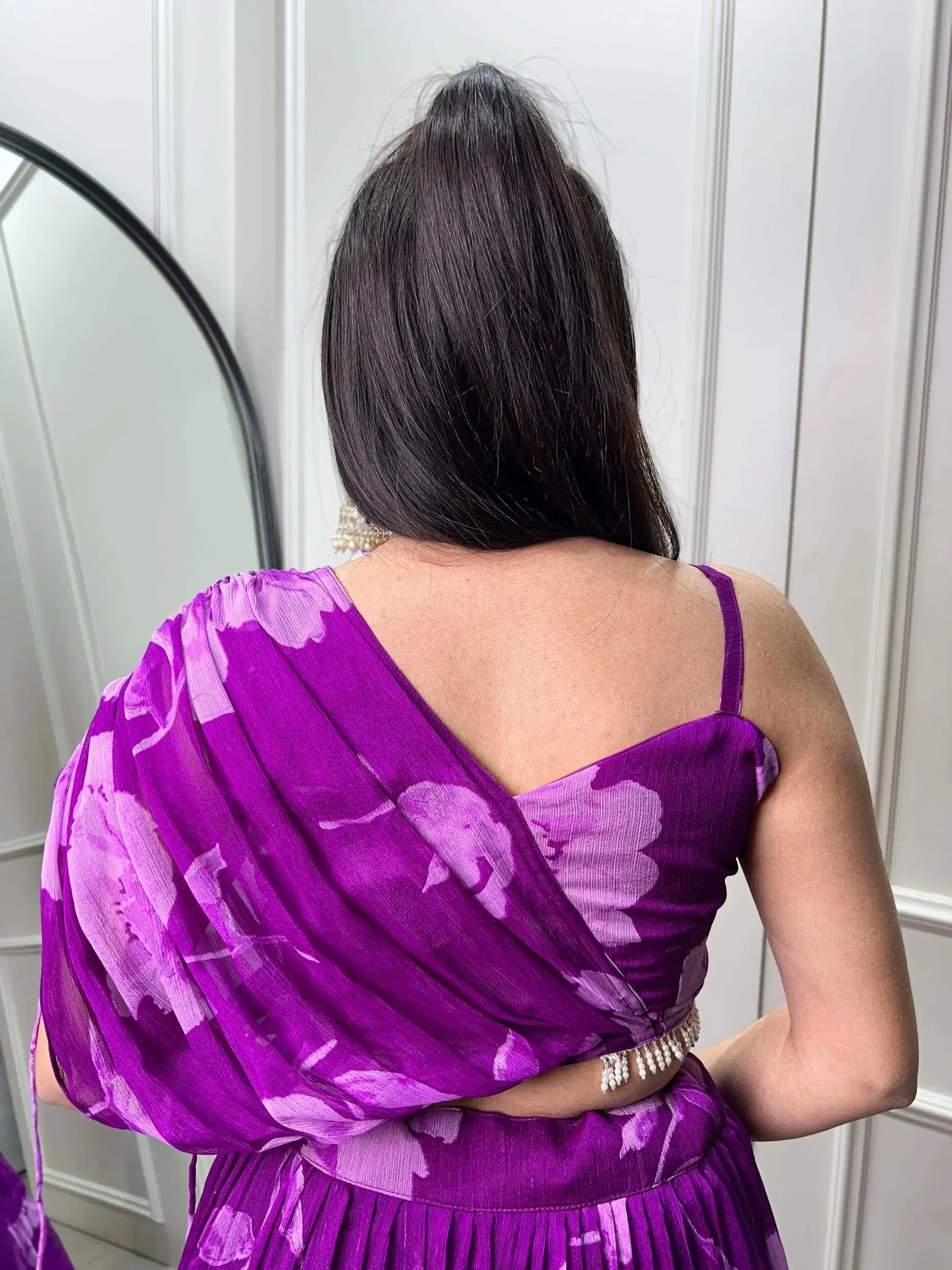 Purple floral ethnic gown with draped back and pearl belt, perfect for Indian occasions