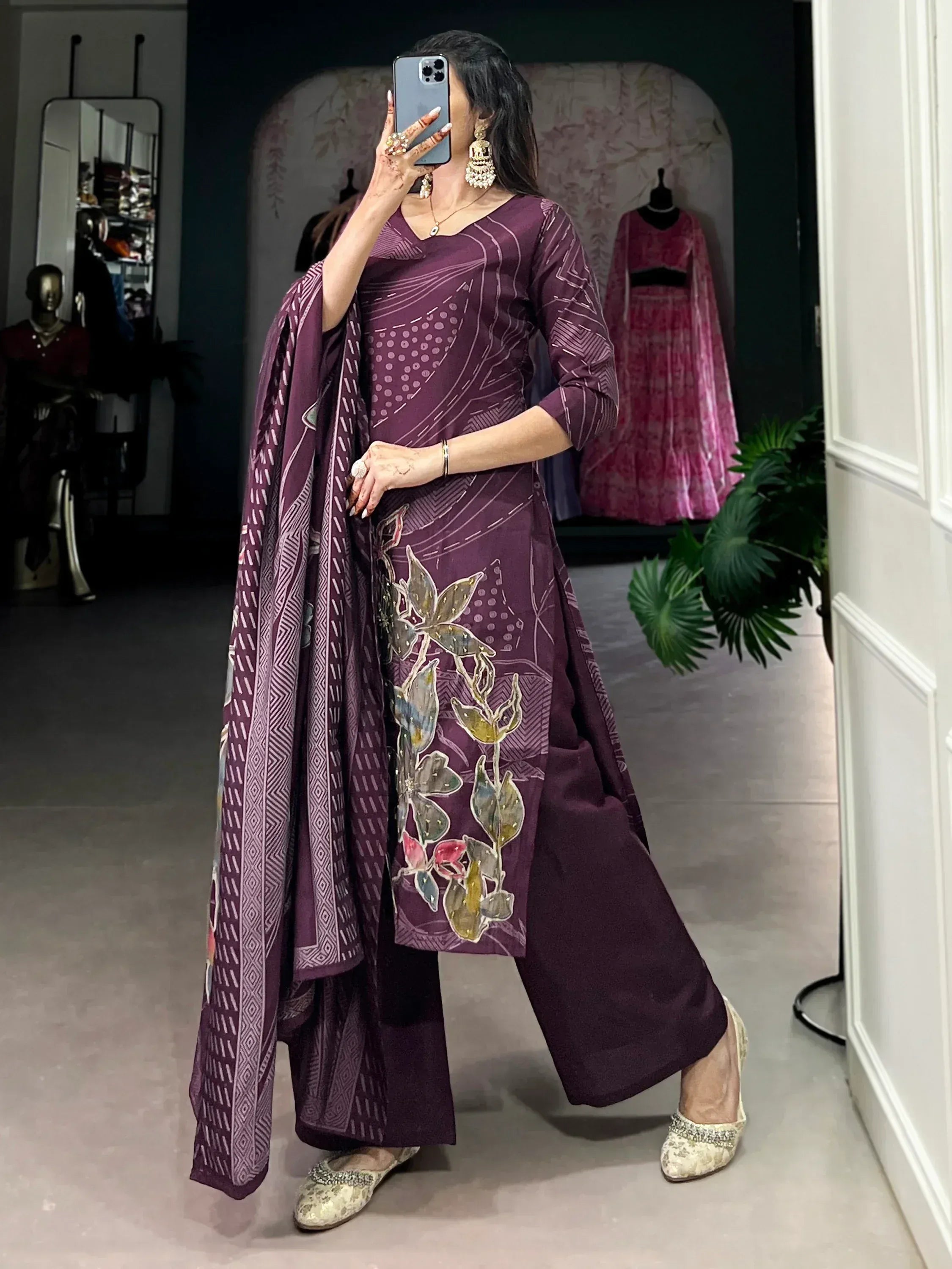 Purple ethnic salwar kameez with floral embroidery and matching dupatta, styled with juttis for Indian wear