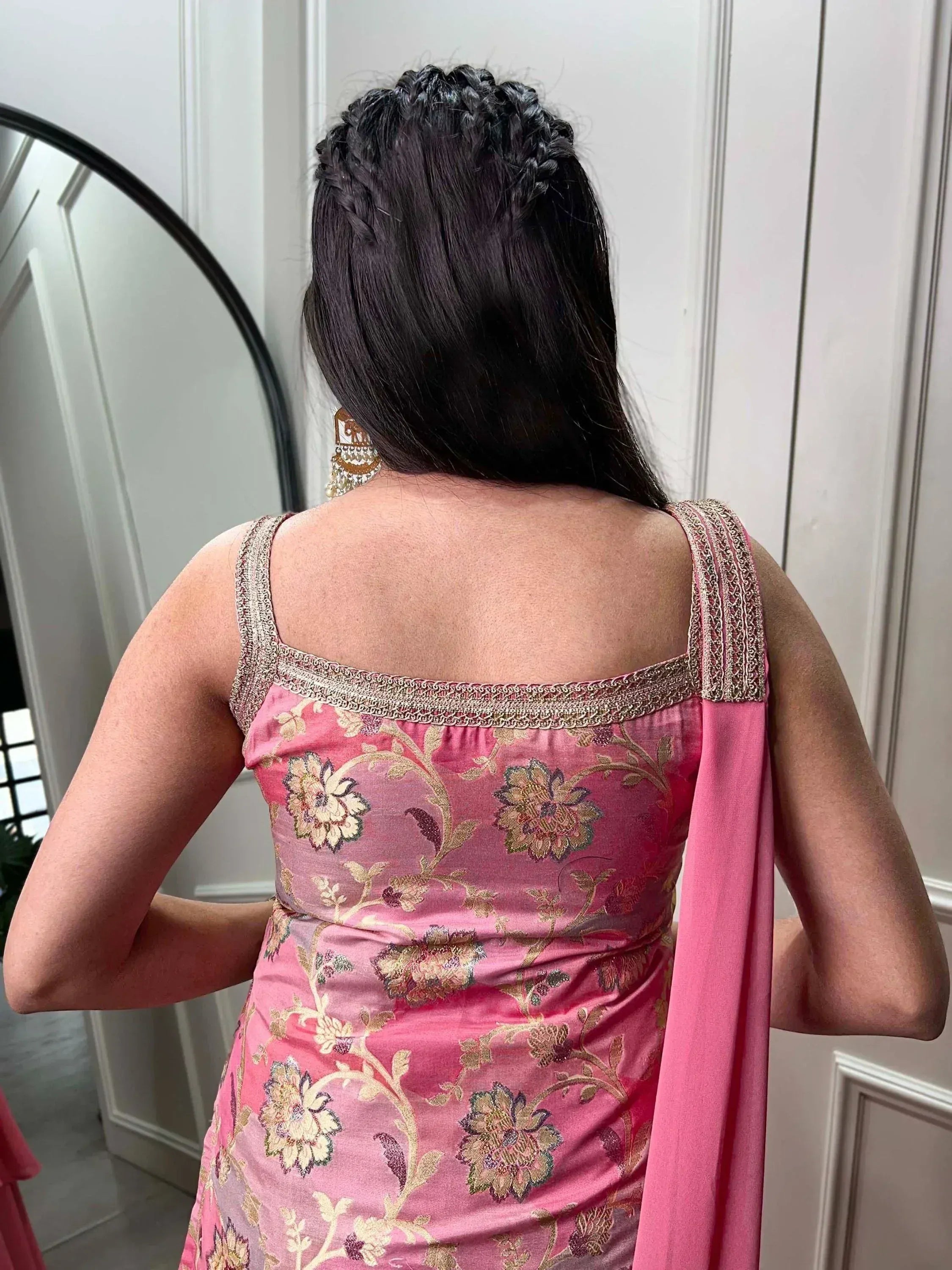 Pink floral ethnic gown with gold embroidery, back view, braided hairstyle, traditional Indian wear