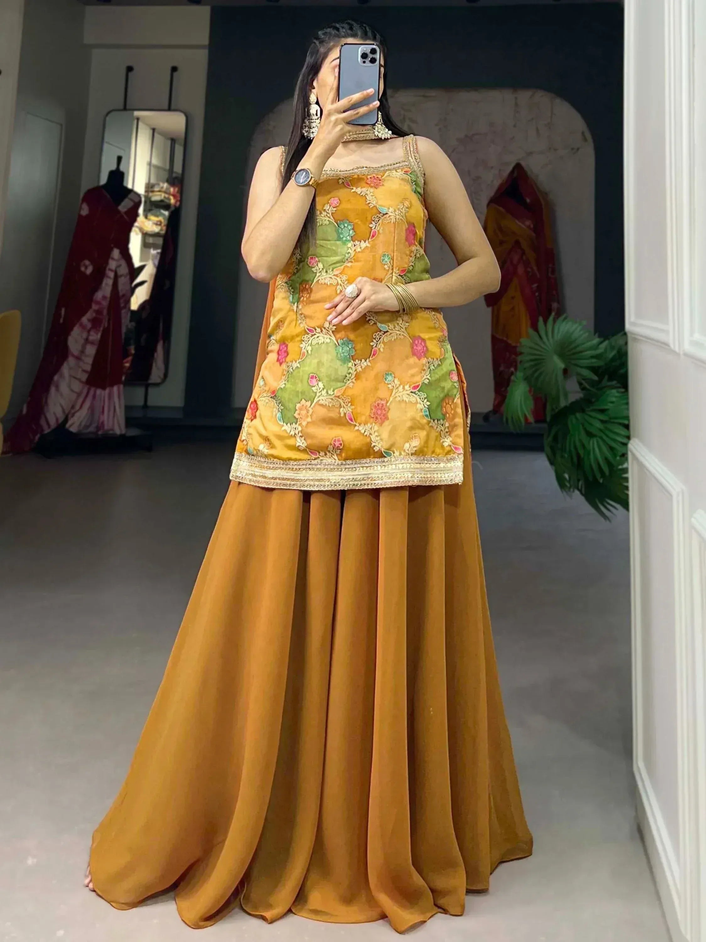 Woman in mustard yellow embroidered ethnic gown with floral design, perfect for Indian festive occasions