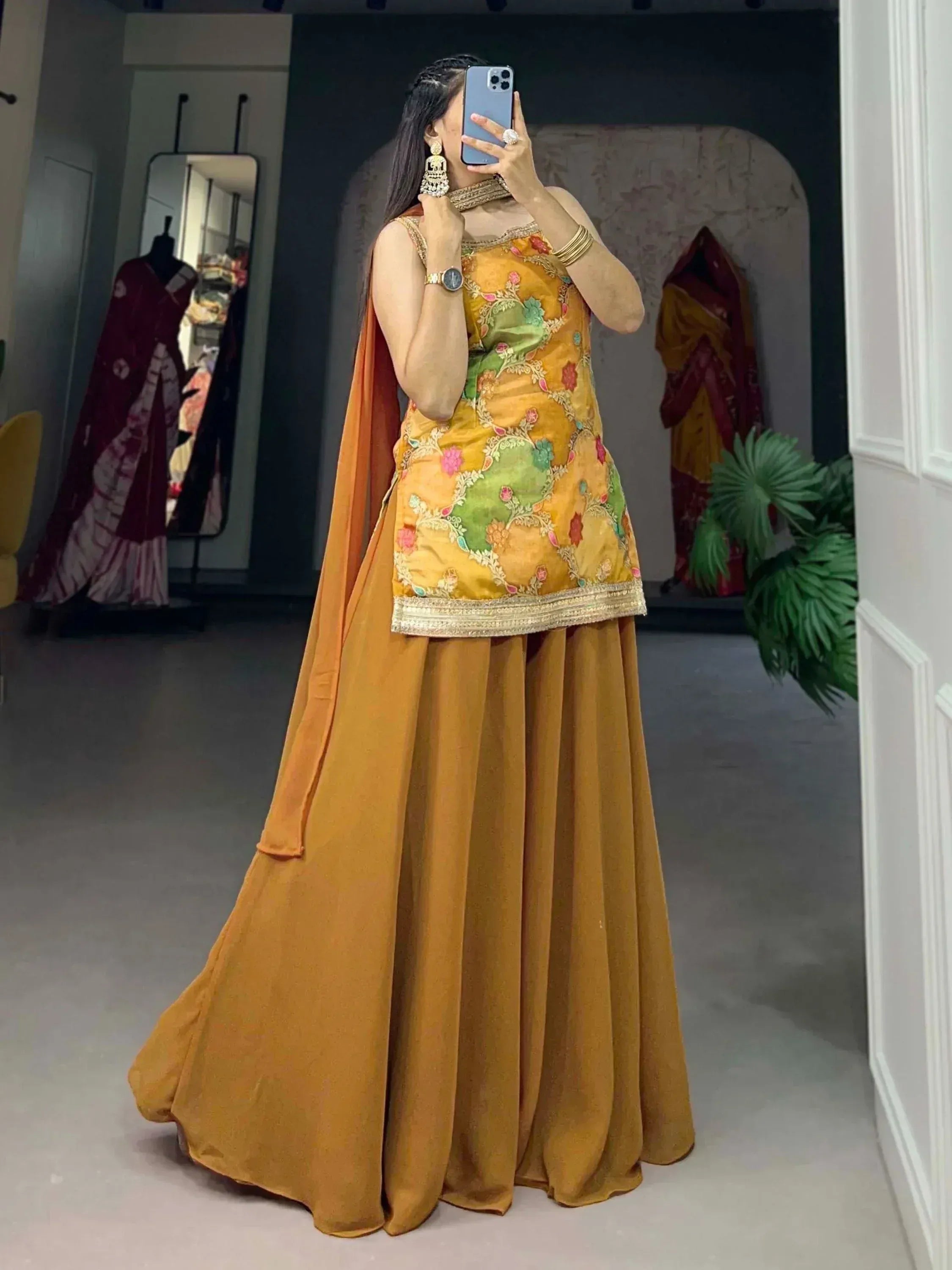 Woman in mustard yellow embroidered lehenga choli with floral design, perfect for Indian ethnic wear occasions.
