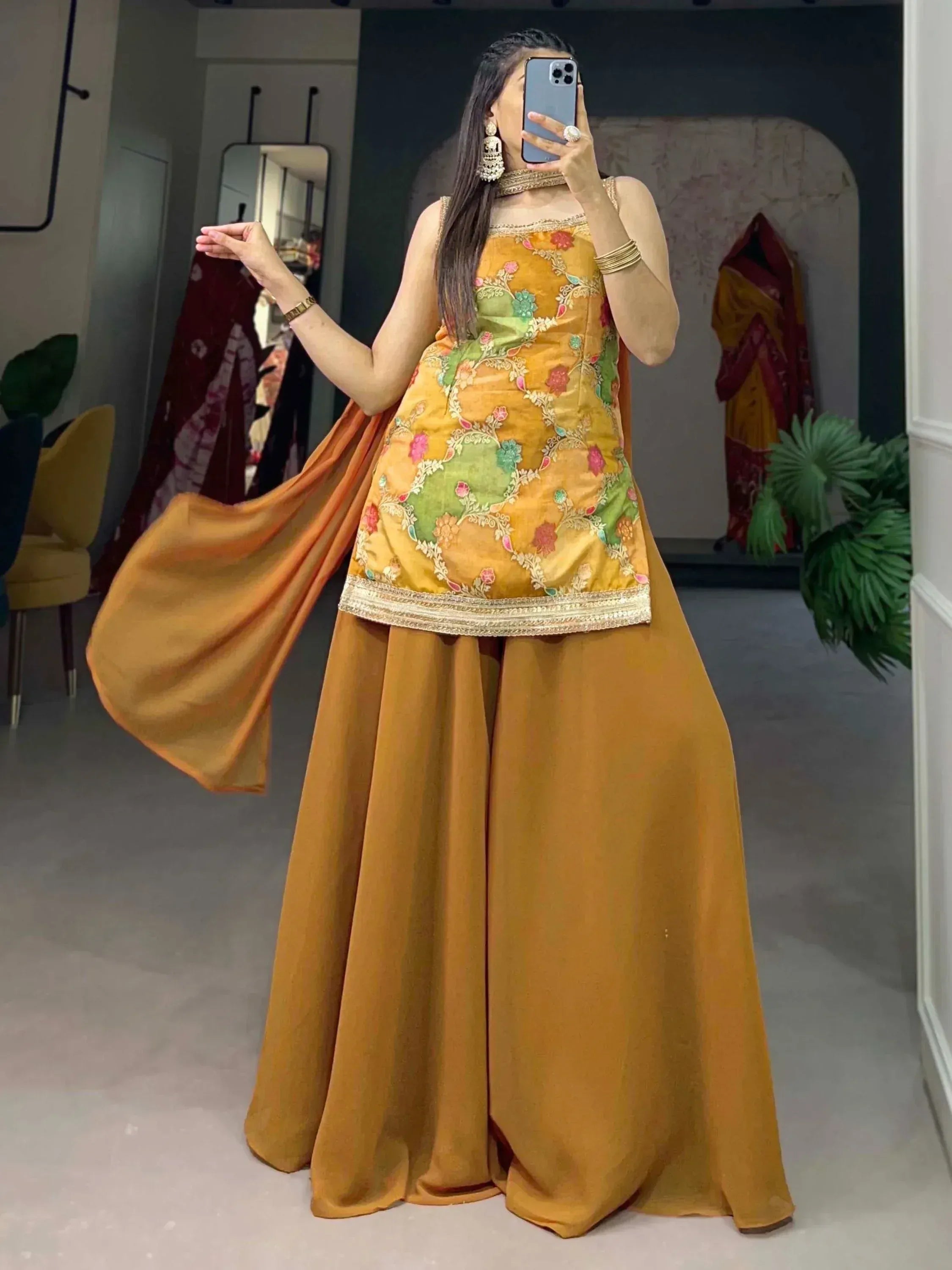 Mustard yellow embroidered ethnic sharara suit with floral design and matching dupatta, perfect for Indian occasions.