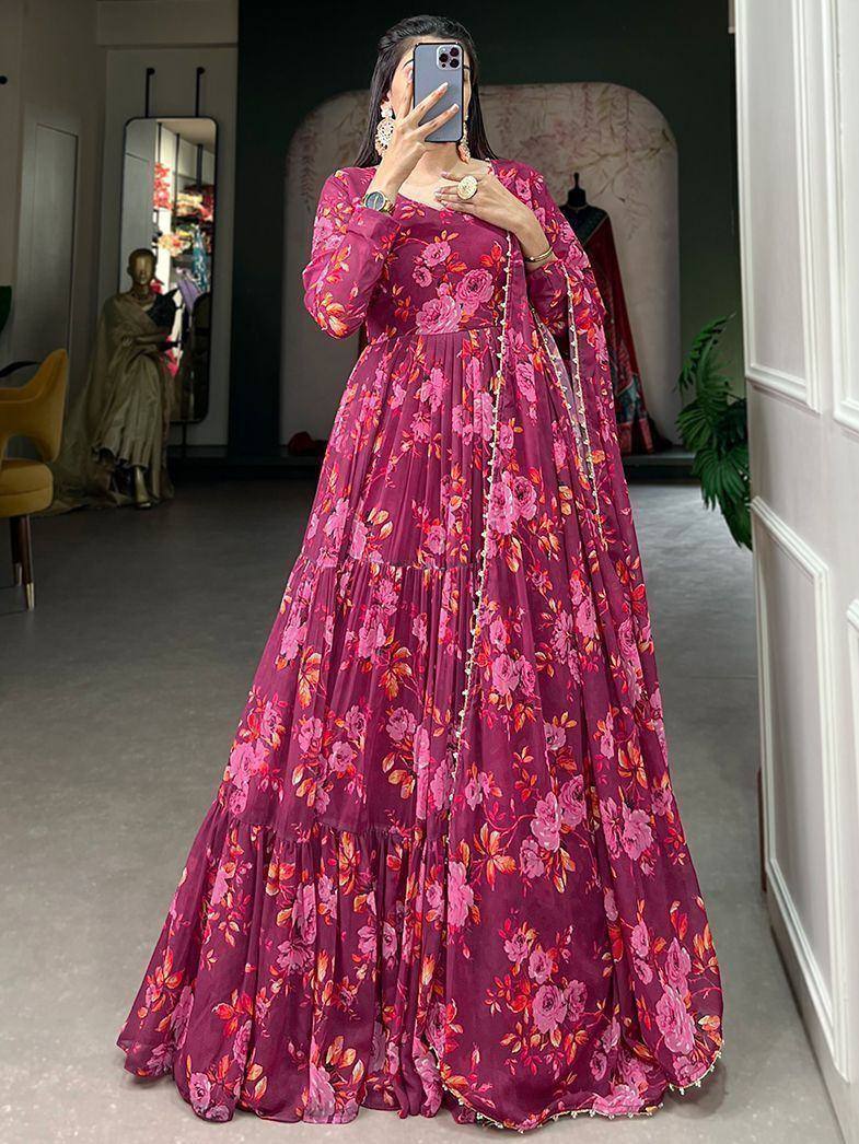 Woman in pink floral ethnic gown with long sleeves, perfect for festive occasions and weddings.