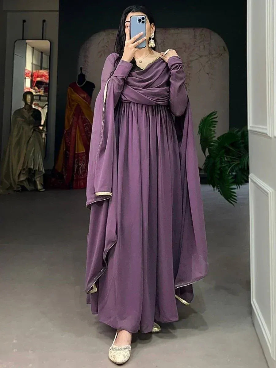 Purple ethnic gown with draped neckline and gold trim, styled with embellished flats for festive occasions