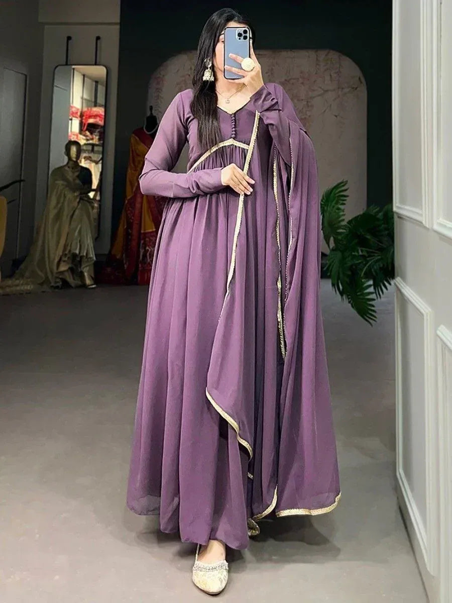 Purple ethnic gown with gold trim, long sleeves, and draped cape for women's festive wear