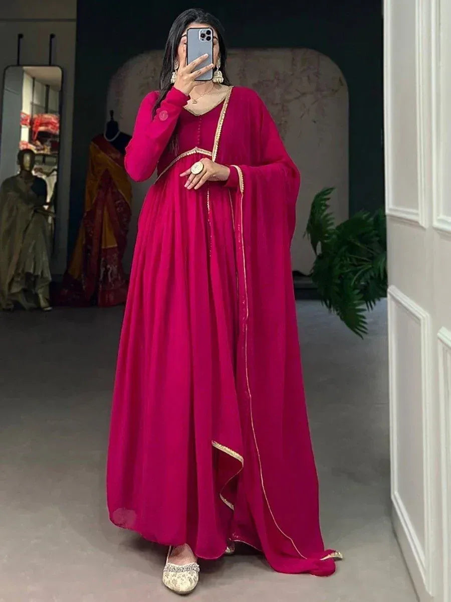 Fuchsia ethnic gown with gold trim, perfect for Indian occasions and festive wear