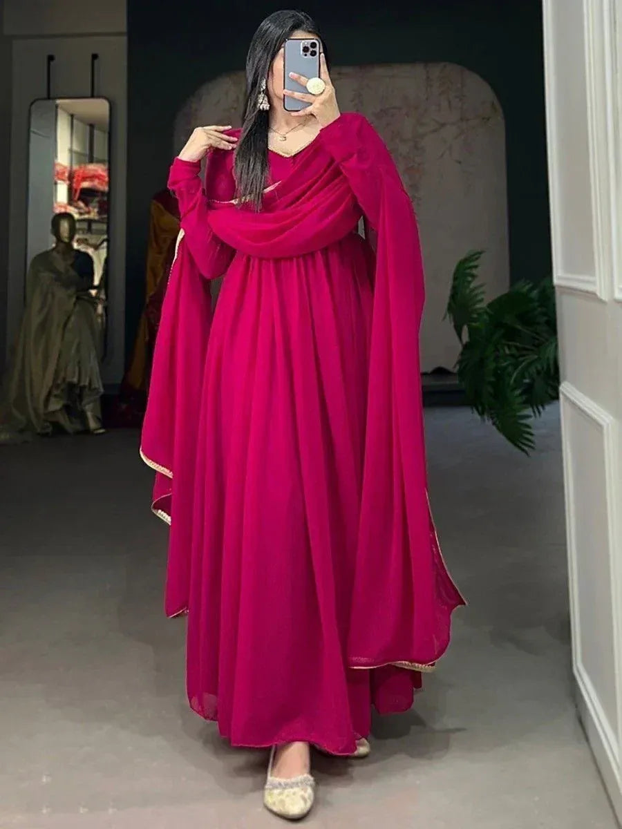 Fuchsia ethnic gown with cape sleeves and gold trim, perfect for Indian occasions