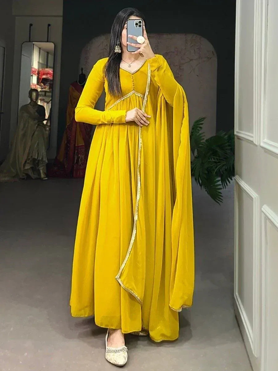 Yellow velvet ethnic gown with gold trim, perfect for Indian occasions and festive wear