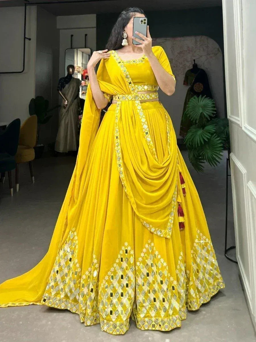 Vibrant yellow designer lehenga choli with mirror work and drape, perfect for Indian ethnic occasions