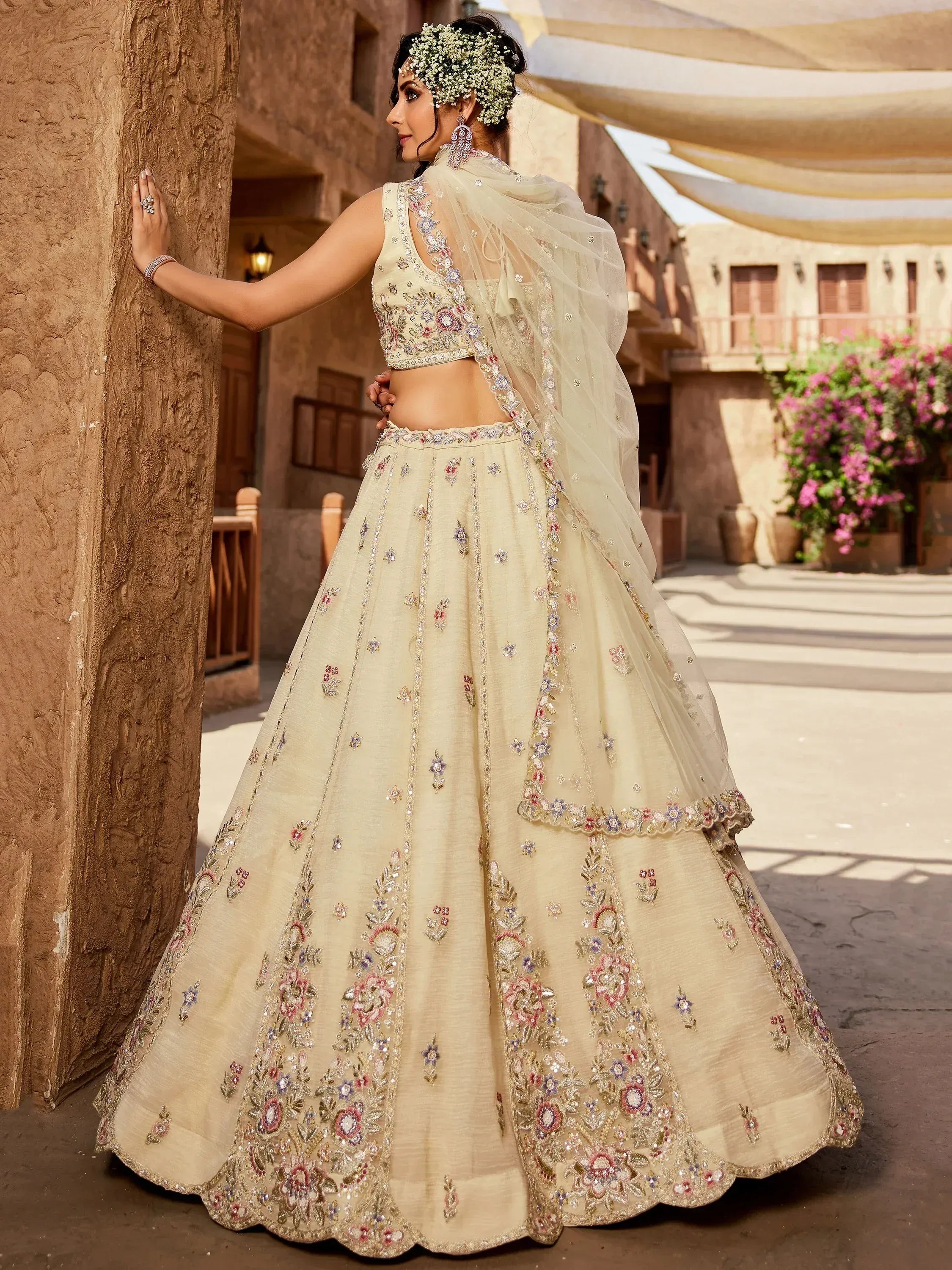 Cream floral embroidered lehenga choli with sheer dupatta, perfect for Indian weddings and festive occasions.