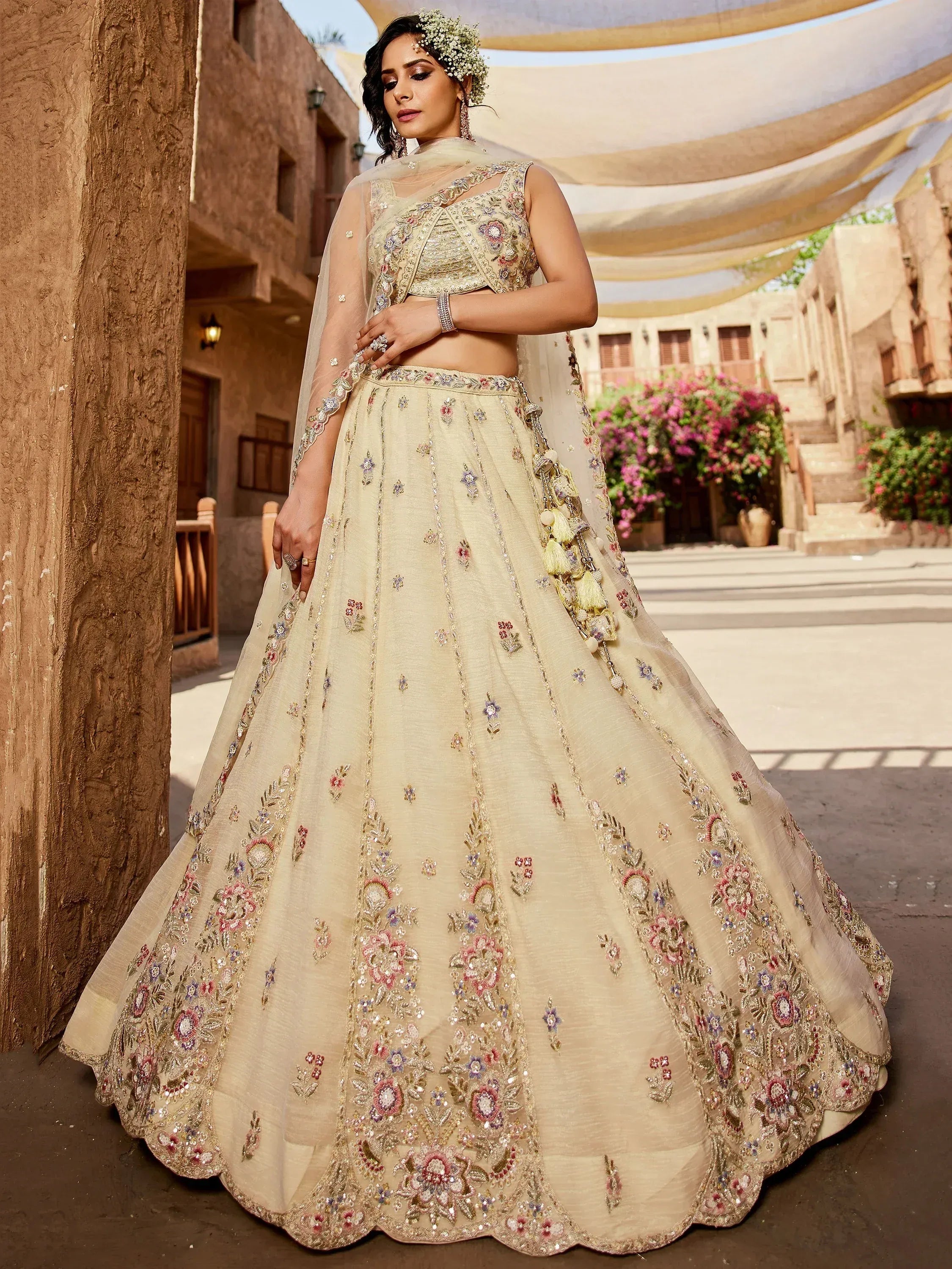 Elegant cream lehenga choli with floral embroidery, perfect for Indian weddings and festive occasions.