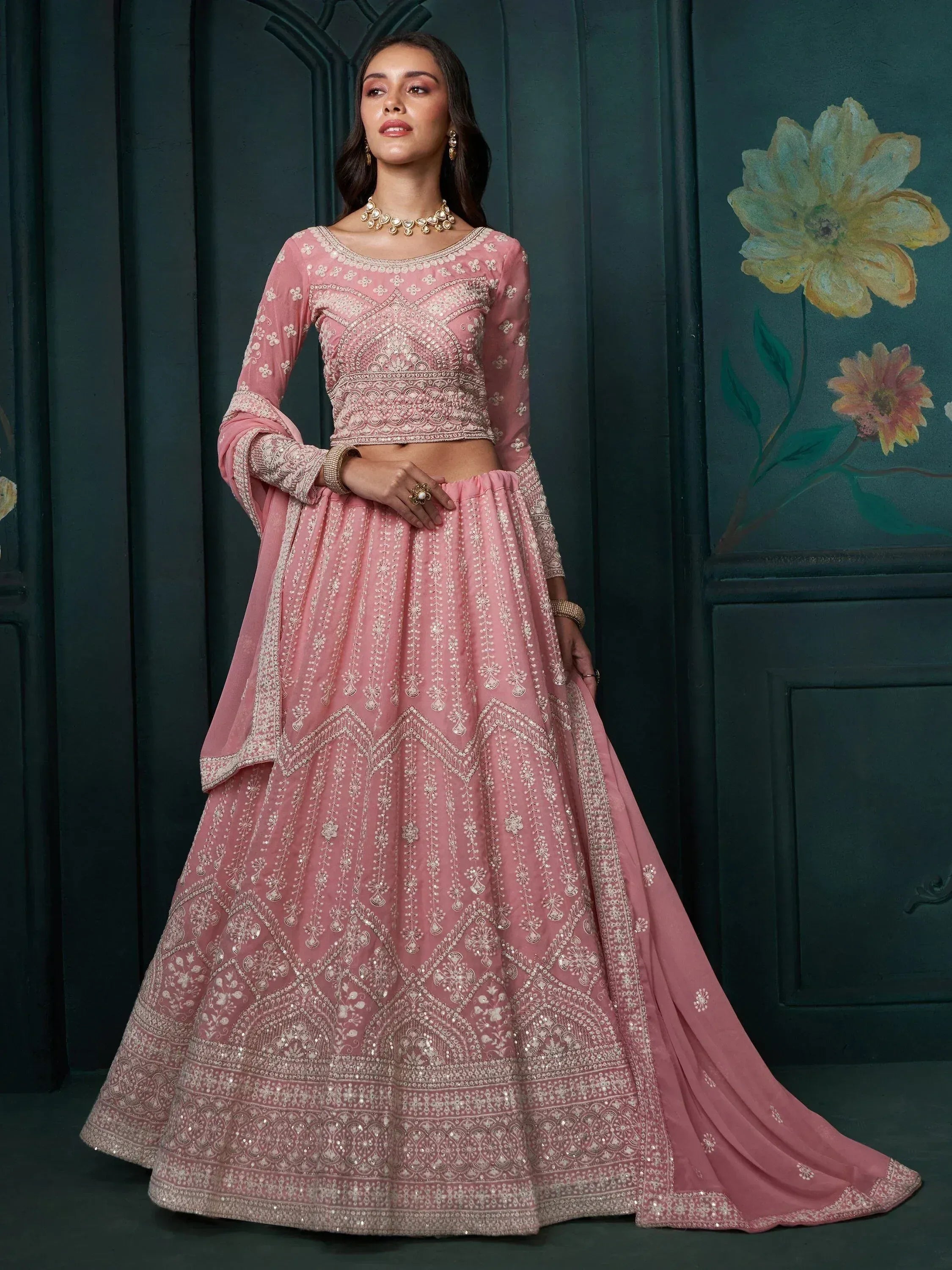 Elegant pink embroidered lehenga choli with intricate designs, perfect for Indian ethnic wear.