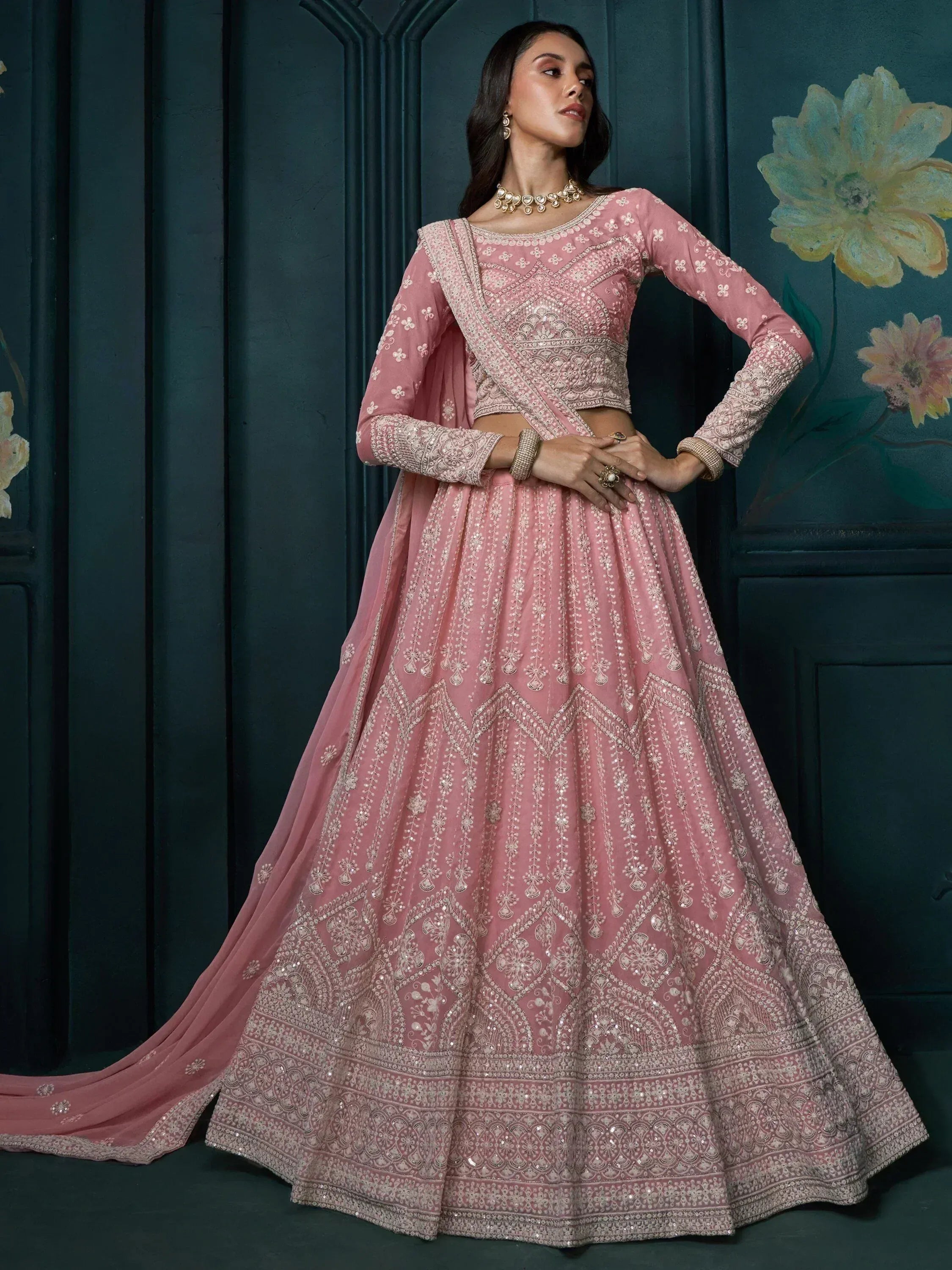 Elegant pink designer lehenga choli with intricate embroidery and embellishments for festive occasions