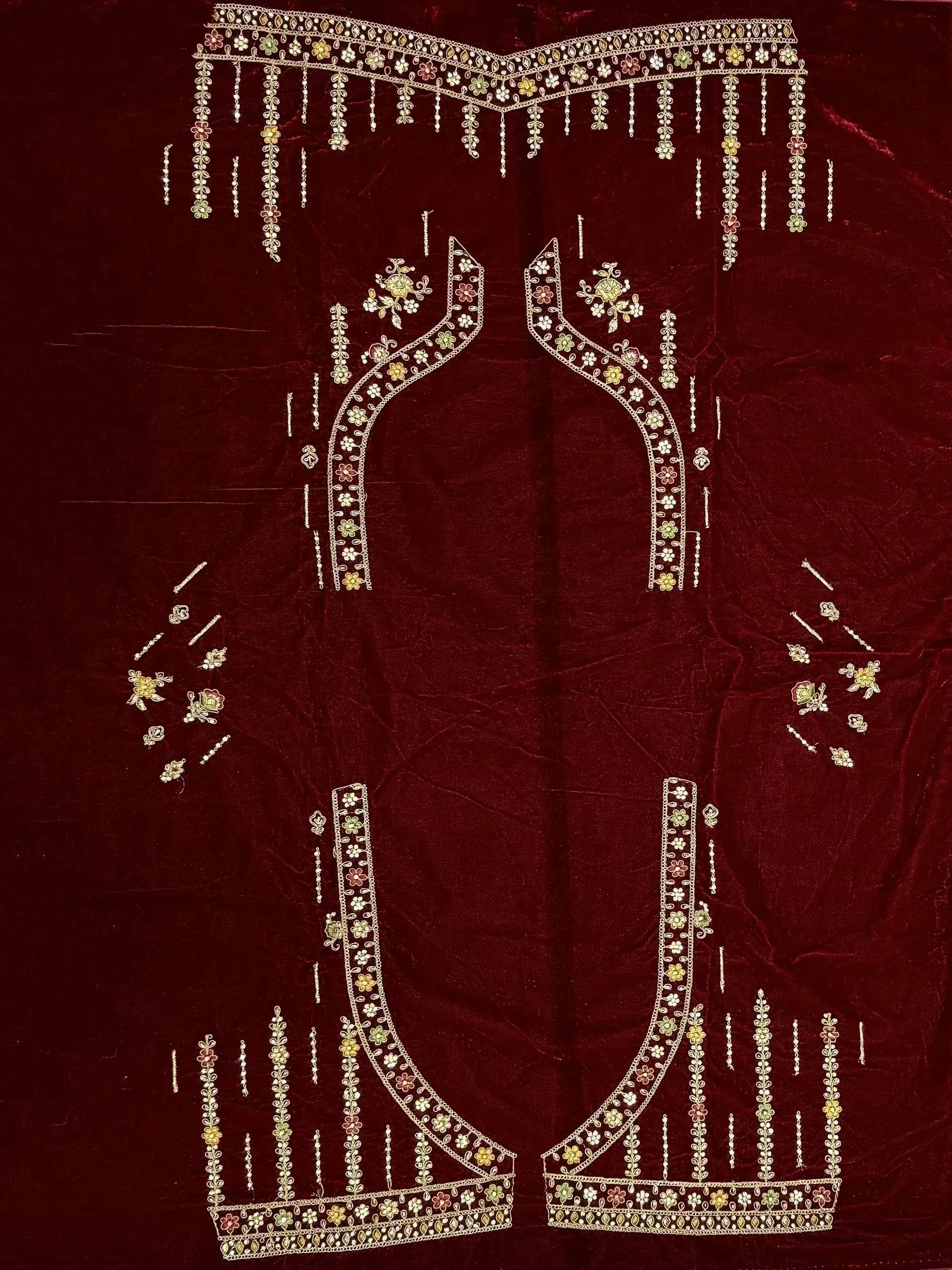 Maroon velvet lehenga choli with floral embroidery and dangling embellishments for Indian ethnic wear