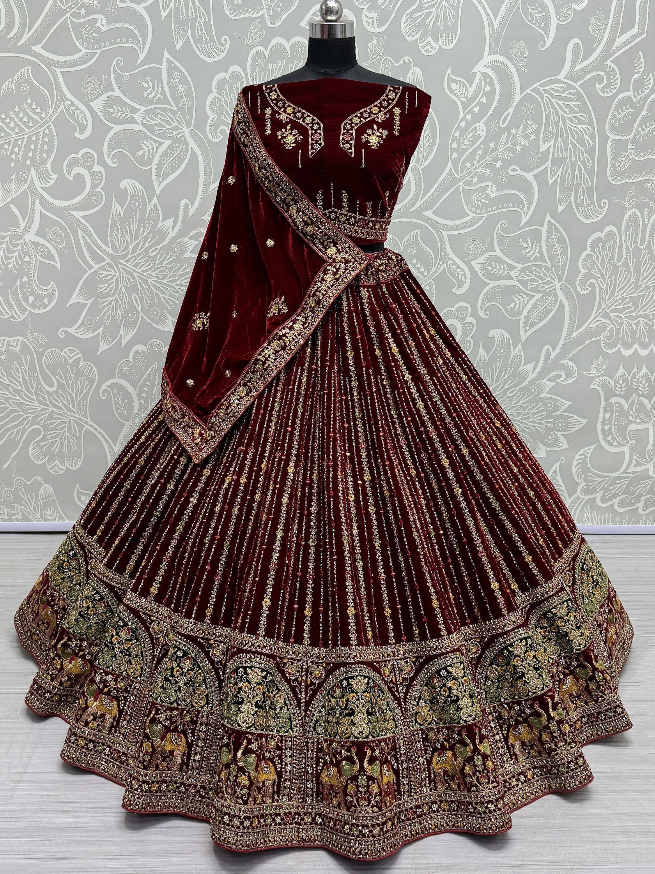 Maroon velvet lehenga choli with gold embroidery and elephant motifs, perfect for Indian weddings and festive occasions.