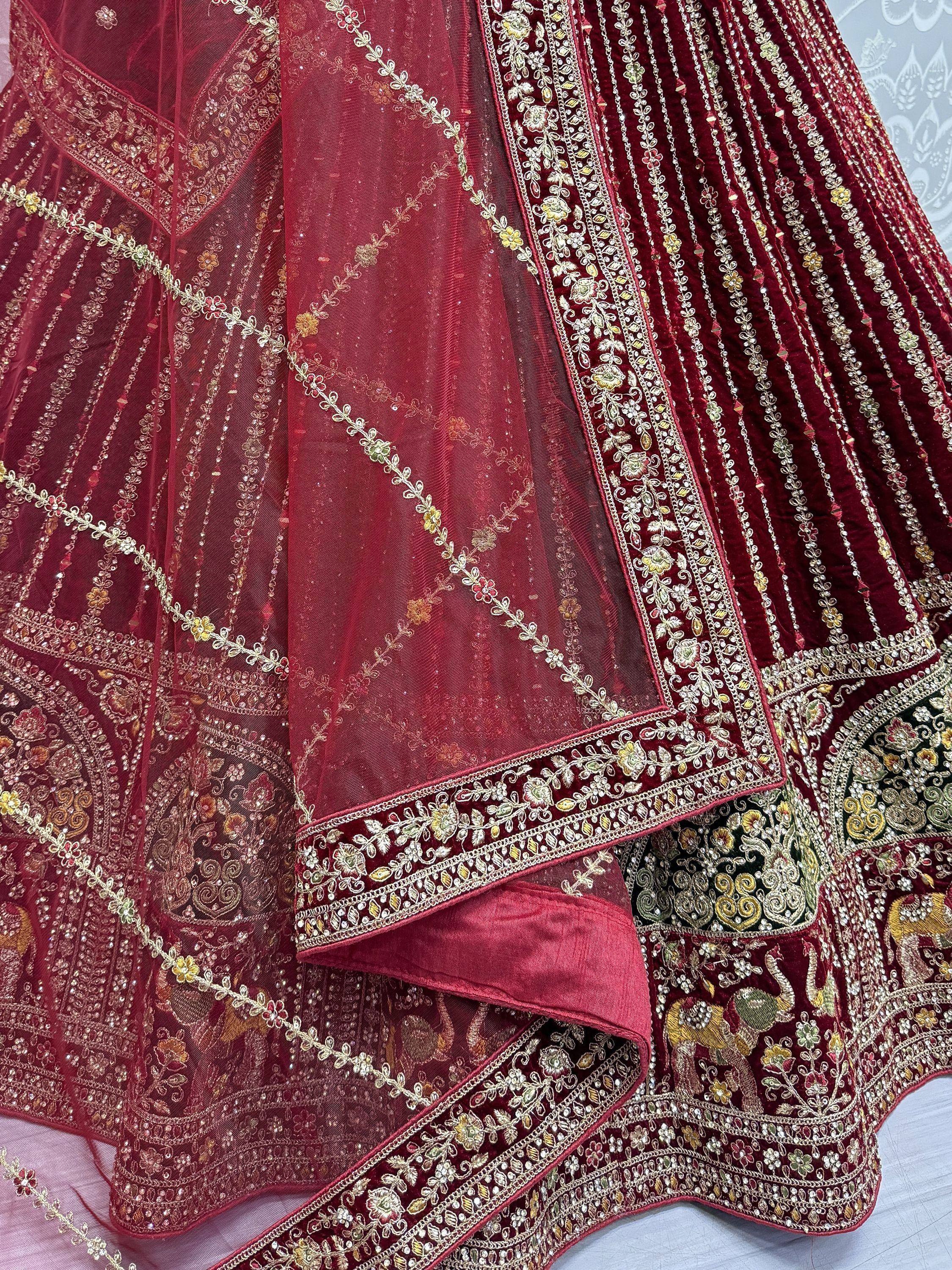 Rich maroon lehenga with intricate gold embroidery and floral patterns, perfect for Indian ethnic wear.