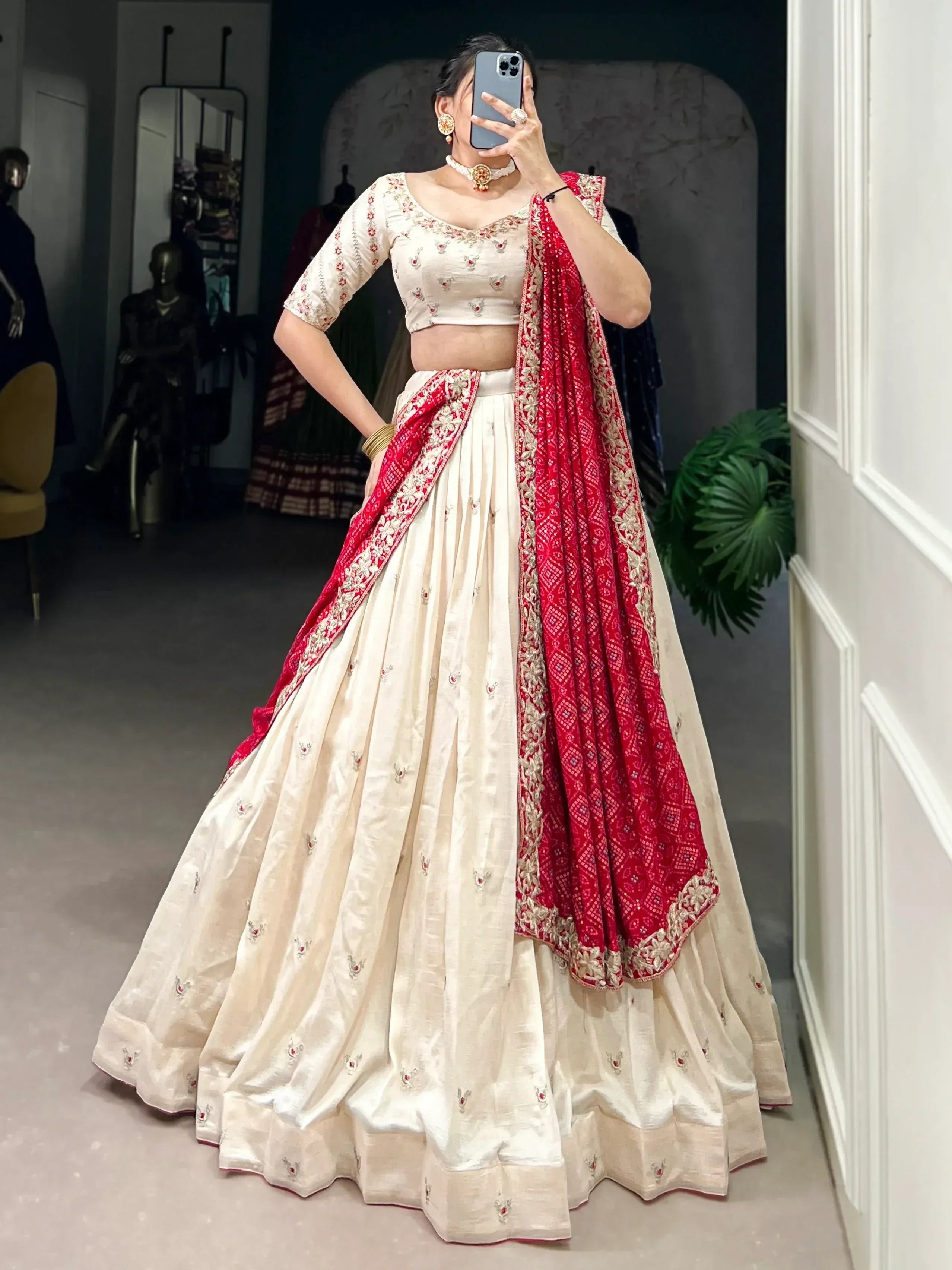Cream and red embroidered lehenga choli with matching dupatta, perfect for Indian ethnic wear occasions.