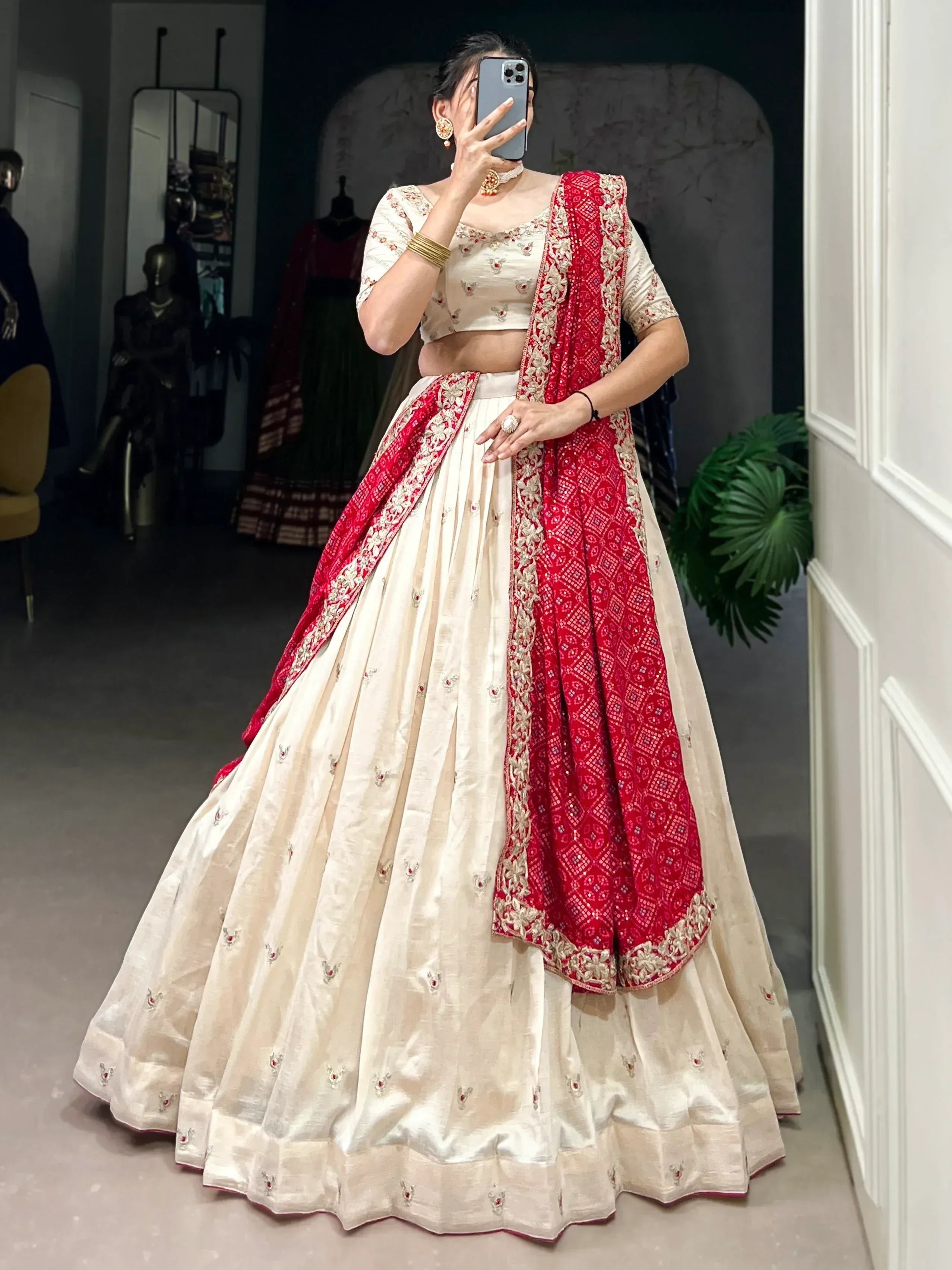 Cream and red embroidered lehenga choli with matching dupatta, perfect for Indian weddings and festive occasions.