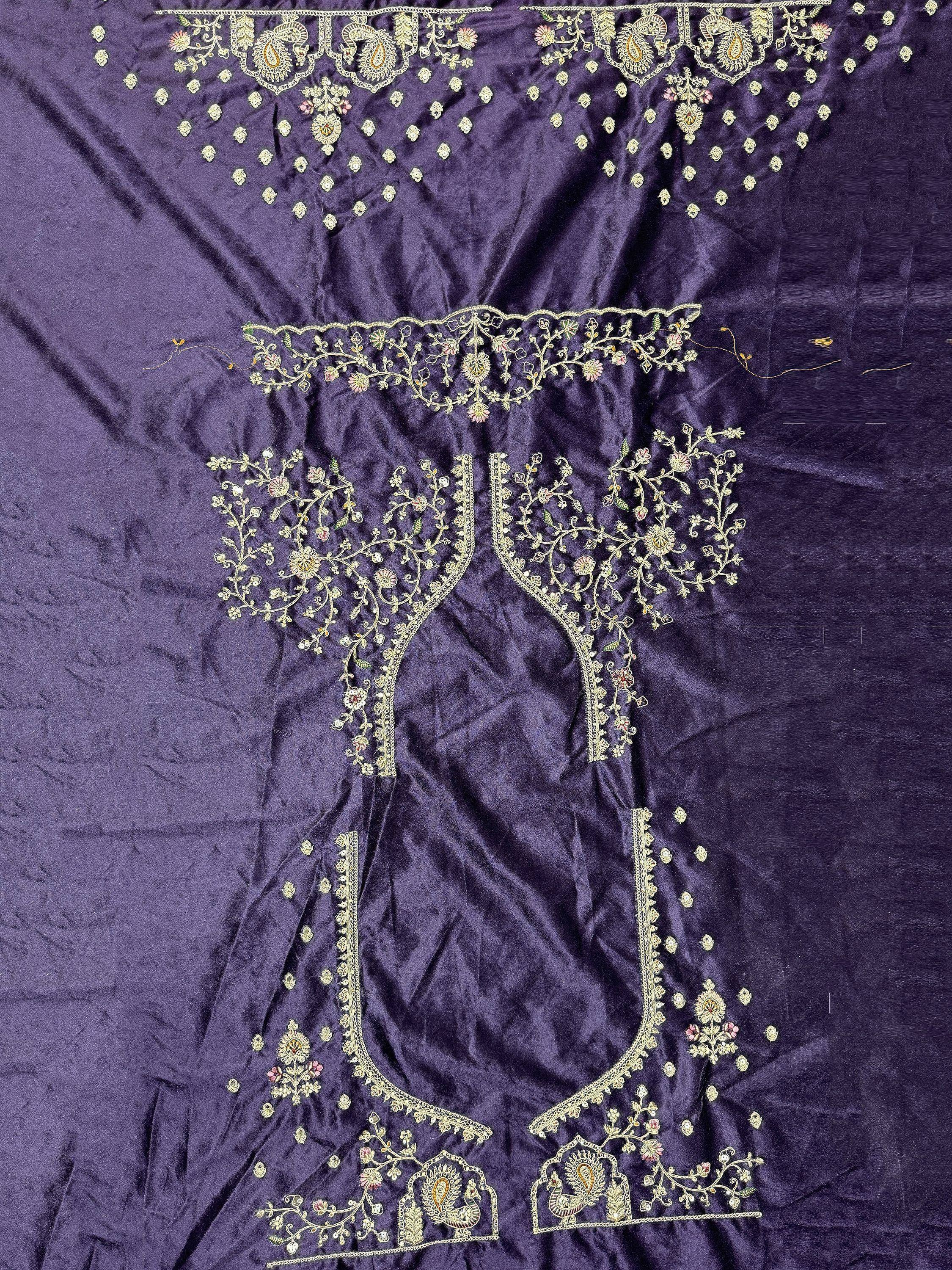 Purple velvet ethnic gown with gold floral and paisley embroidery, perfect for Indian occasions.