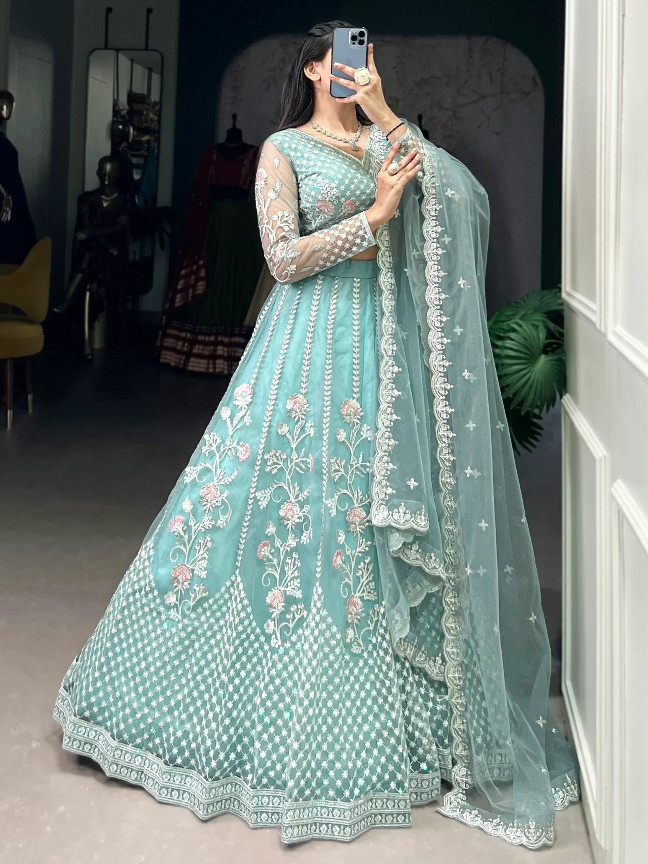Mint green embroidered lehenga choli with sheer sleeves and floral detailing, perfect for Indian ethnic wear.