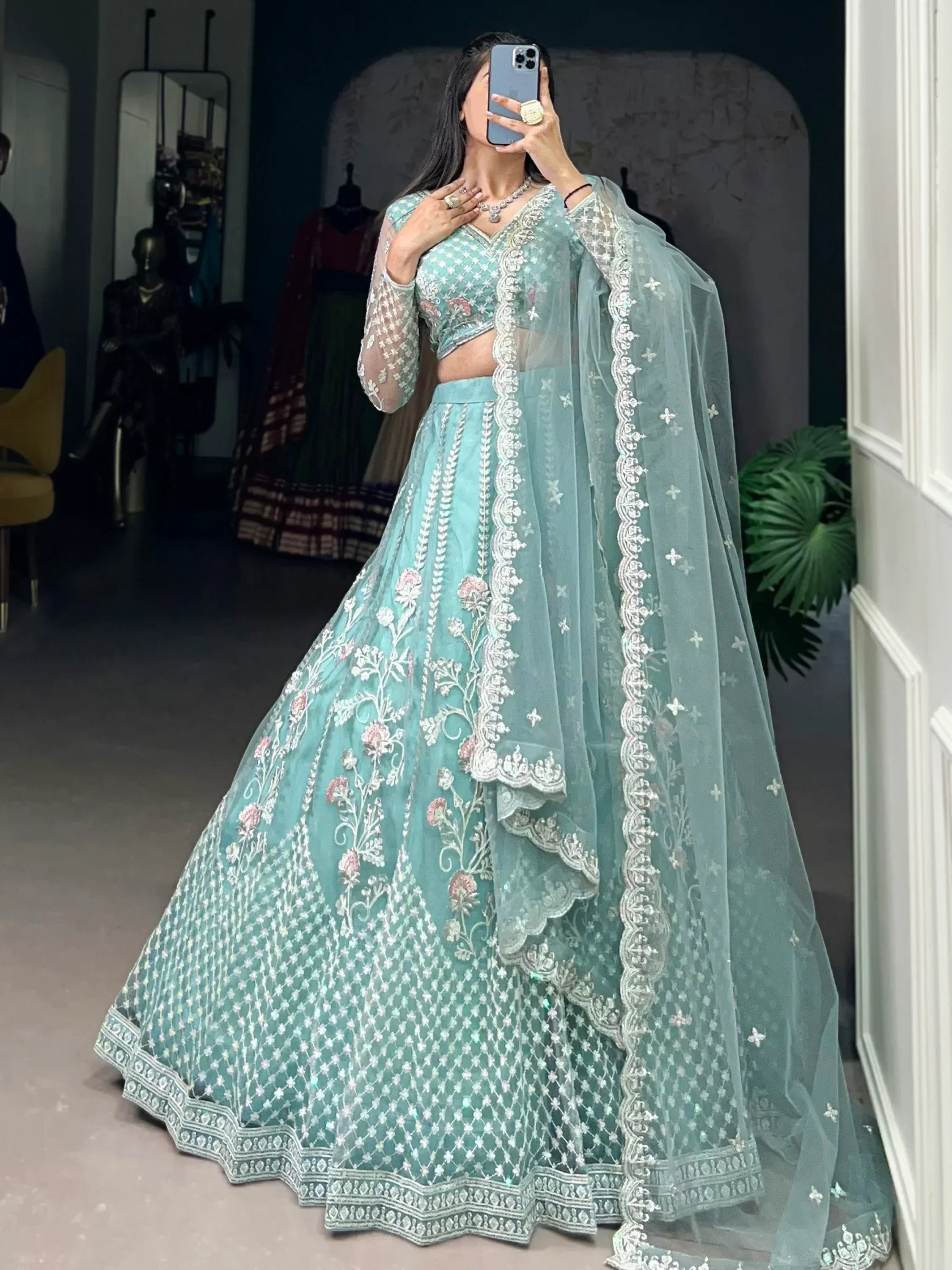 Mint green designer lehenga choli with floral embroidery and sheer dupatta, perfect for weddings and festivals
