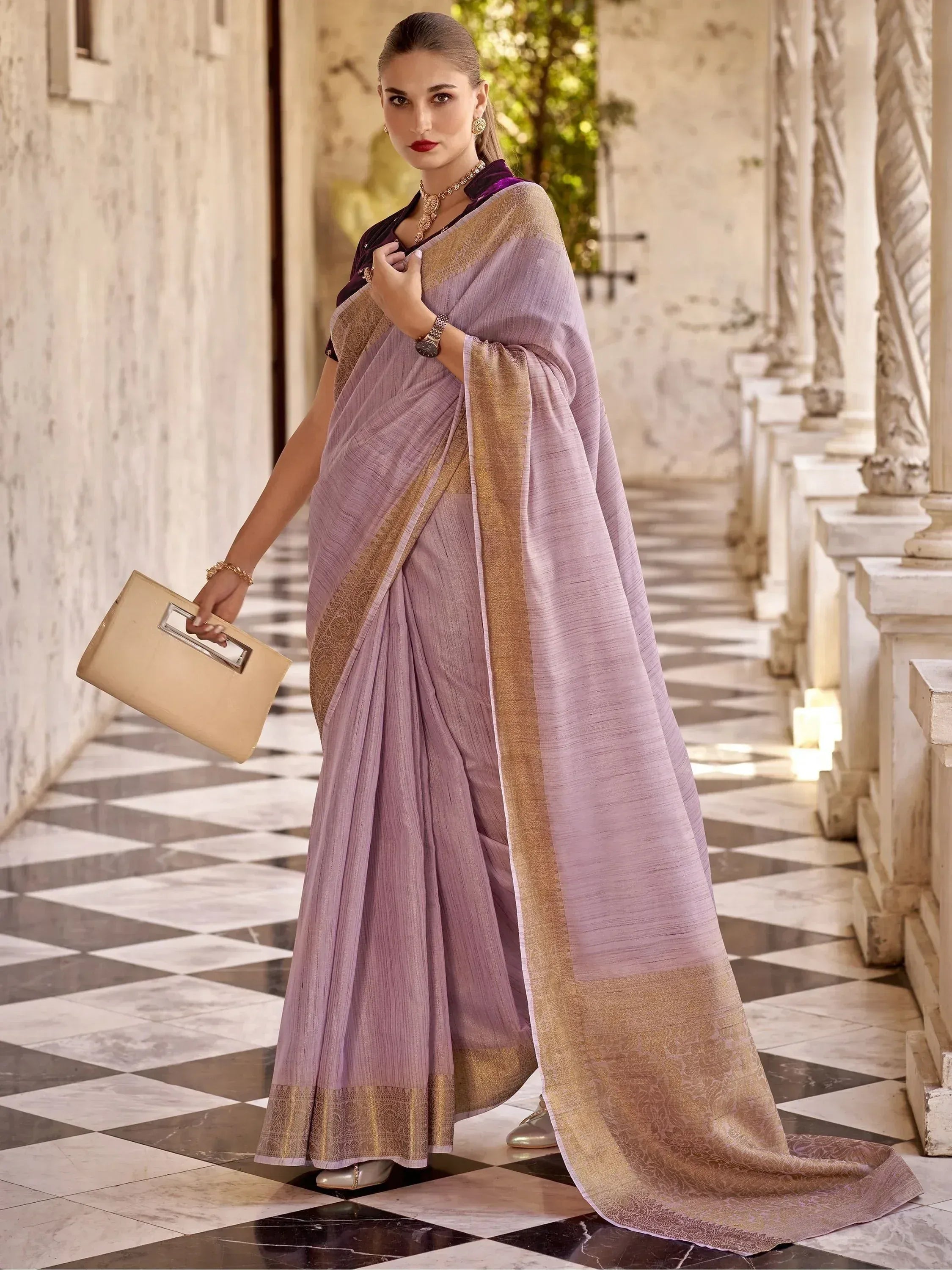 Lavender saree with gold border, ethnic Indian wear for women, styled with clutch and jewelry