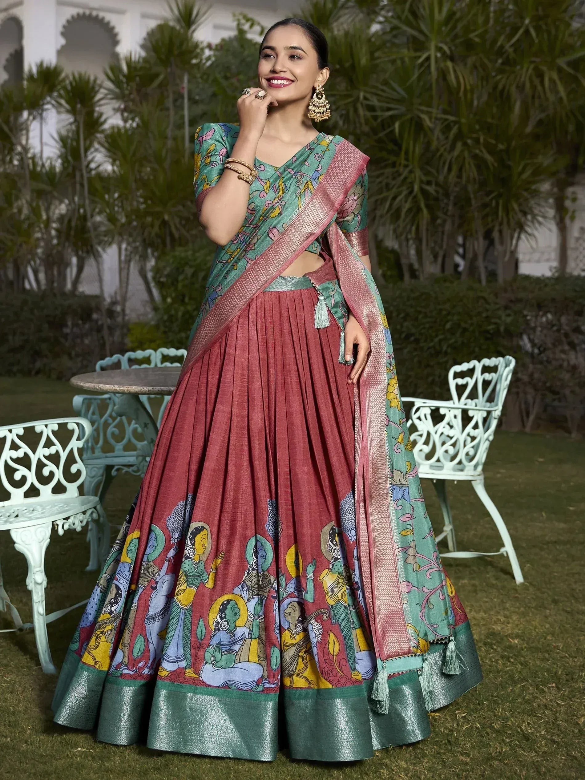 Woman in colorful printed lehenga choli with floral blouse and traditional jewelry, garden setting