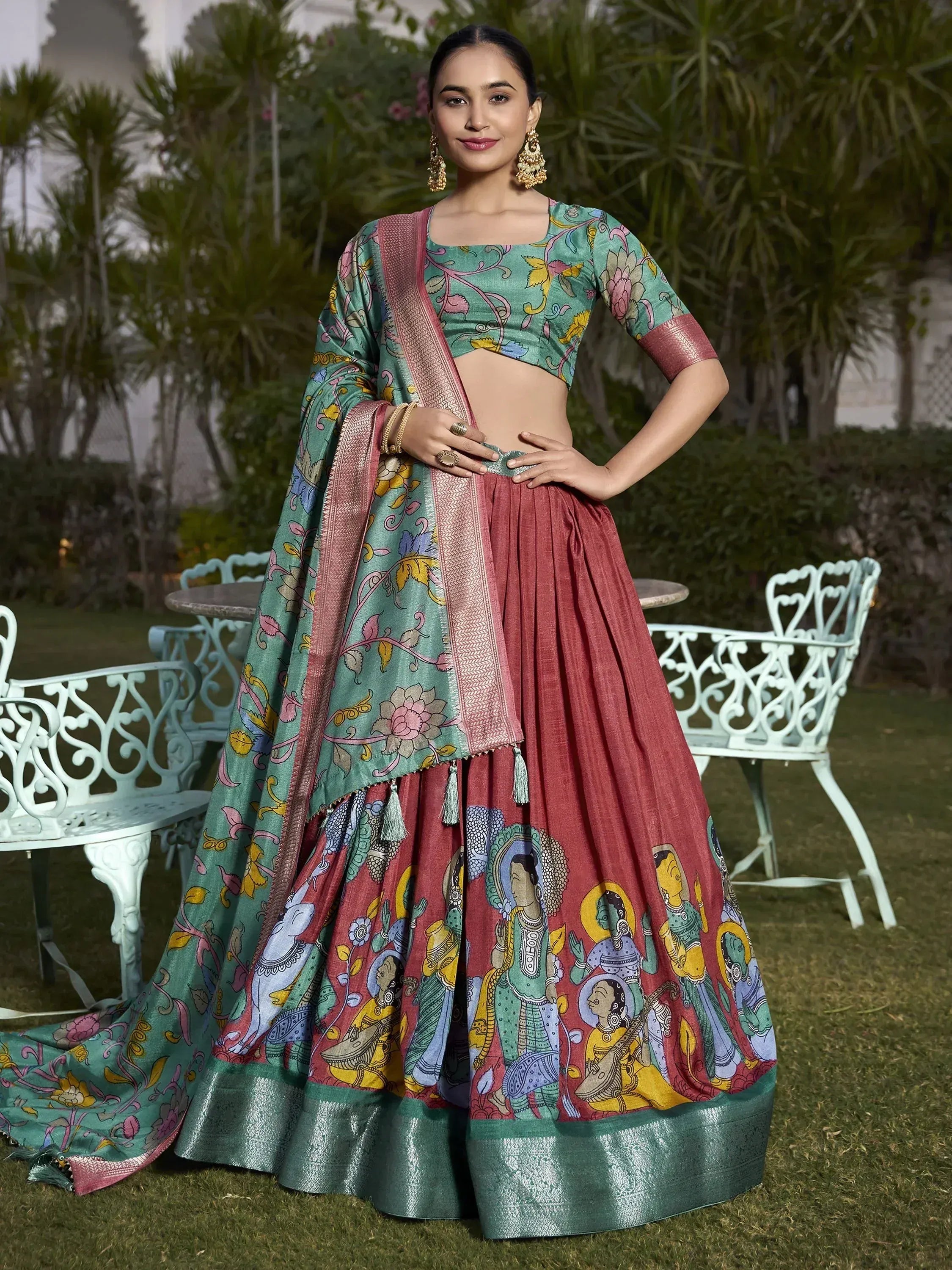 Woman in colorful printed lehenga choli with floral and figurative motifs, perfect for ethnic occasions