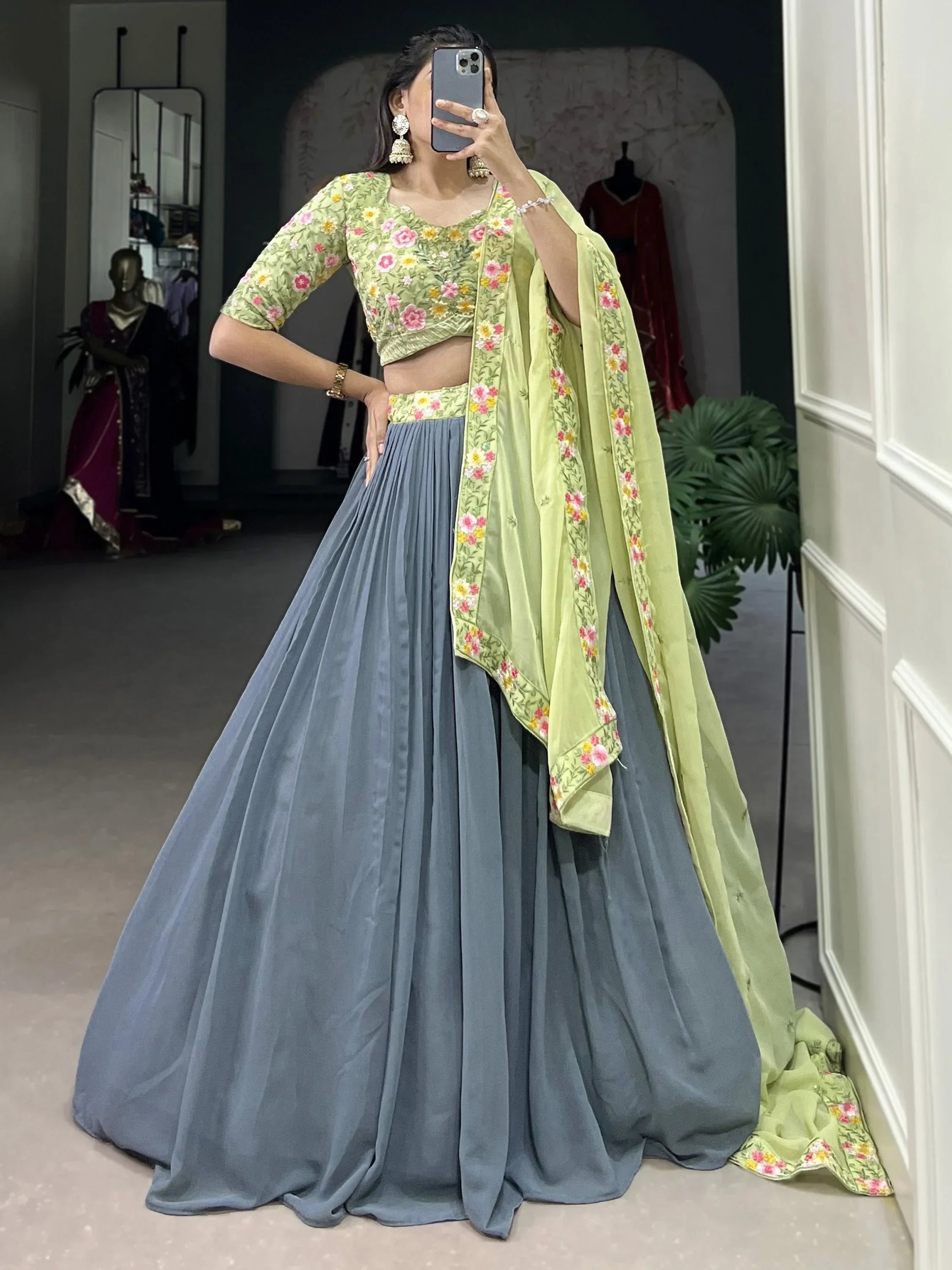 Woman in floral green blouse, grey pleated lehenga, and matching dupatta, Indian ethnic wear