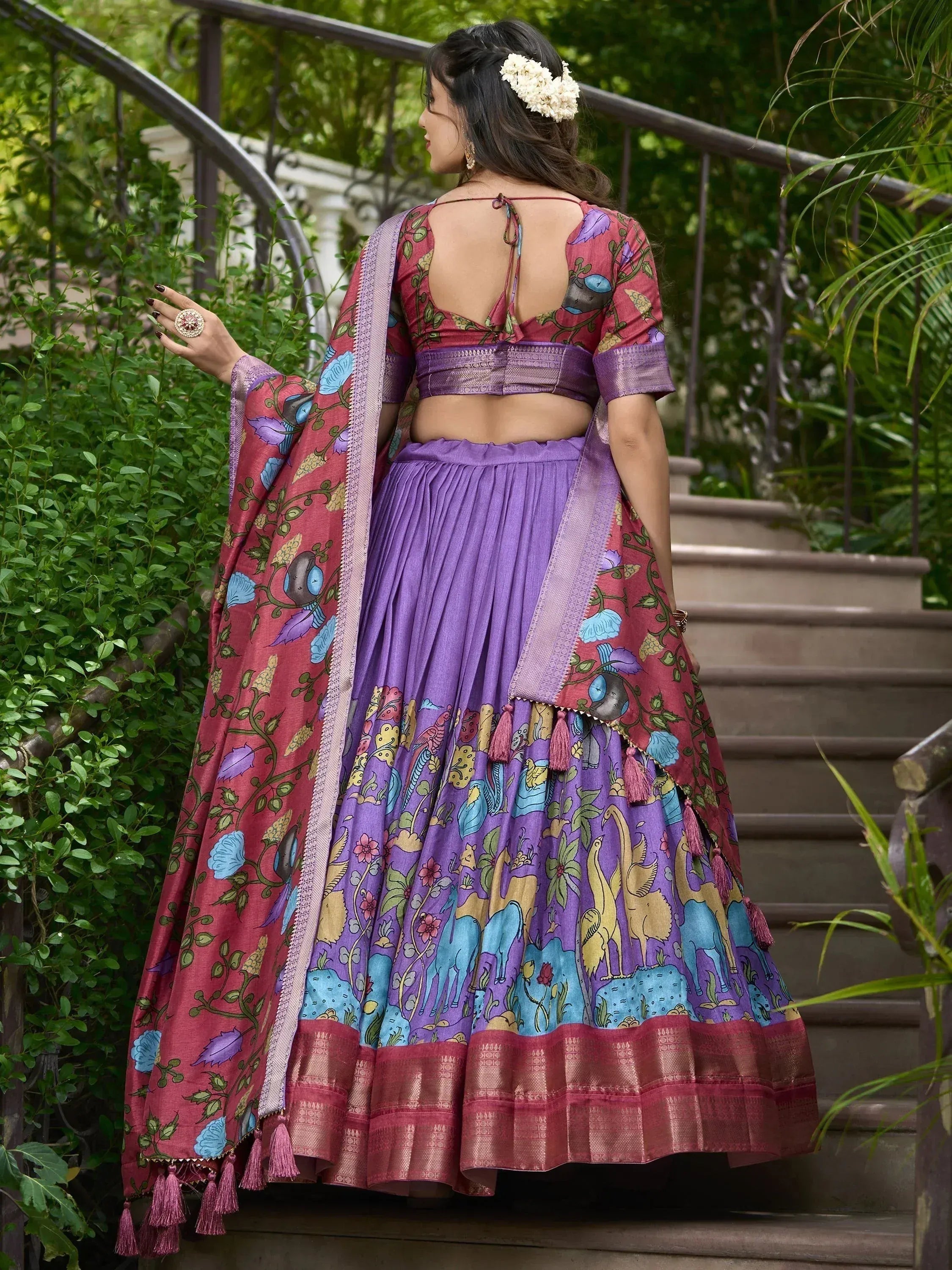 Purple and pink printed lehenga choli with floral and bird motifs, ideal for Indian ethnic occasions.