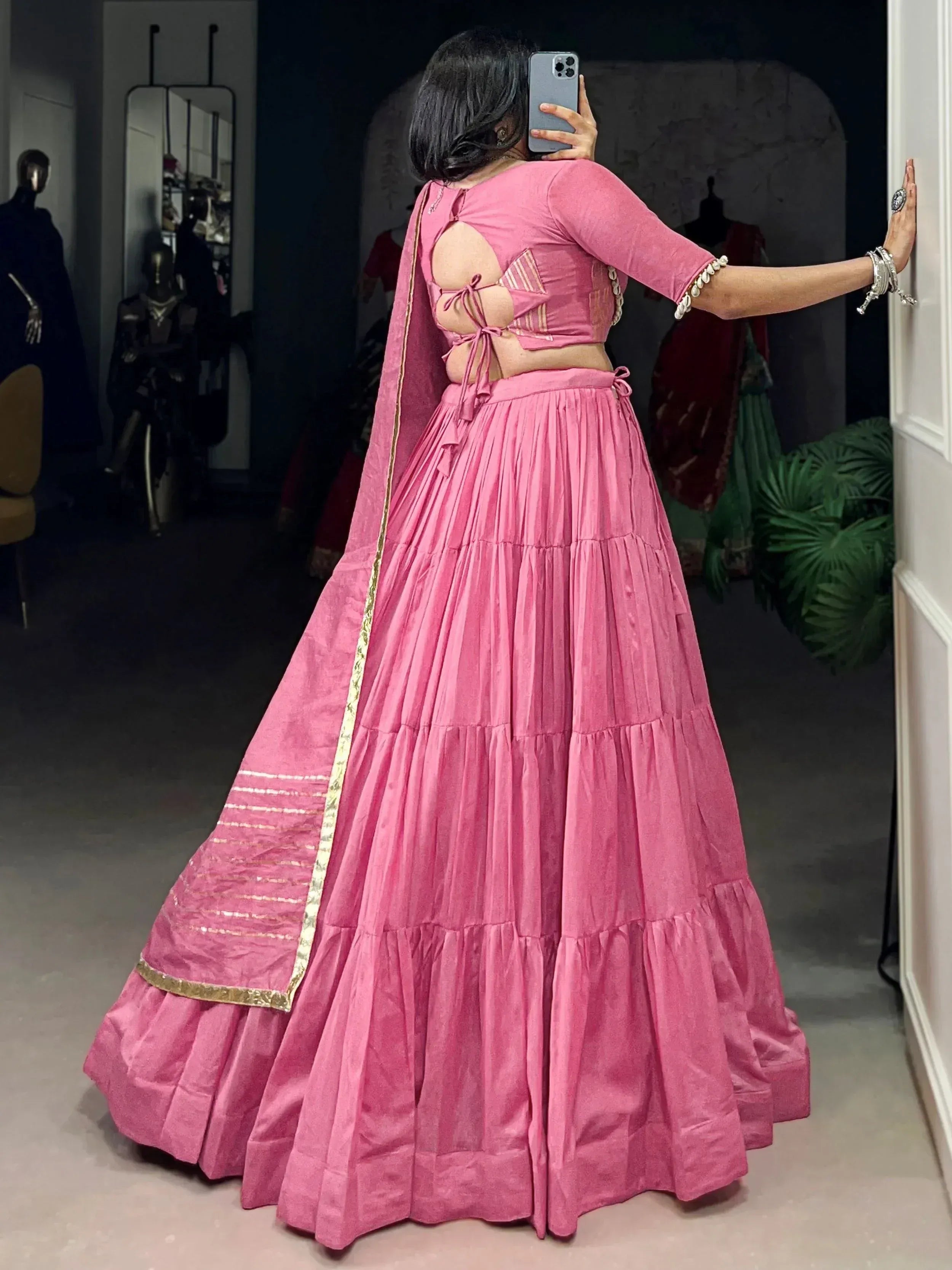 Pink designer lehenga choli with back cutout and gold trim, ethnic Indian wear