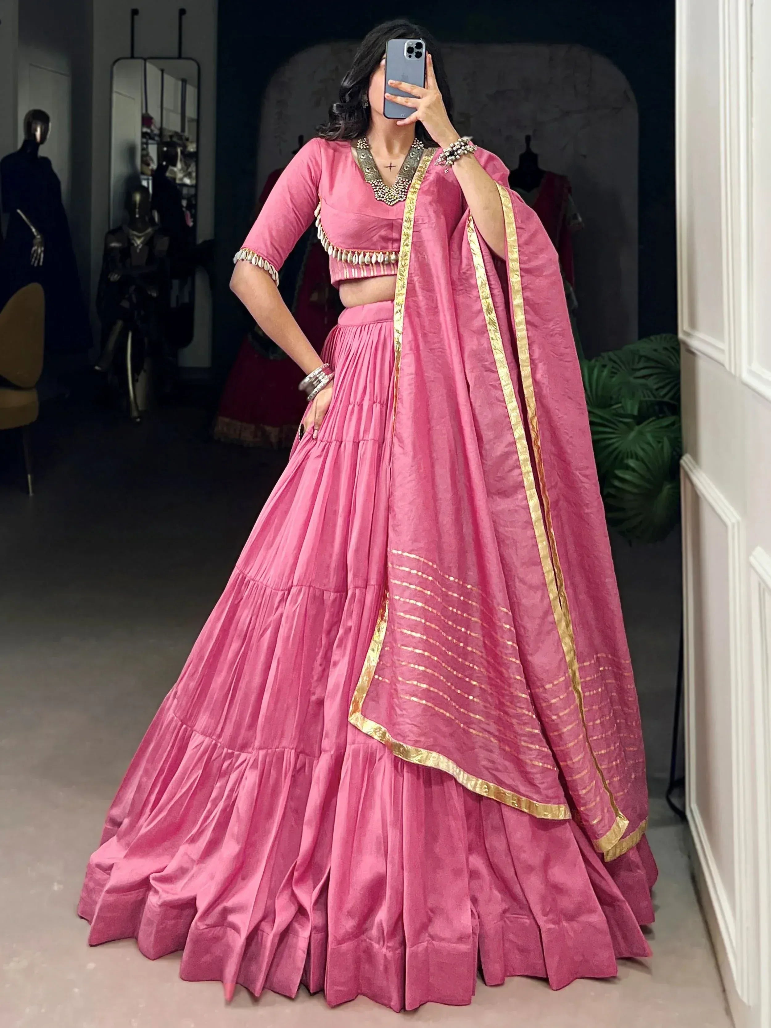 Pink designer lehenga choli with gold trim, perfect for Indian ethnic wear and festive occasions.