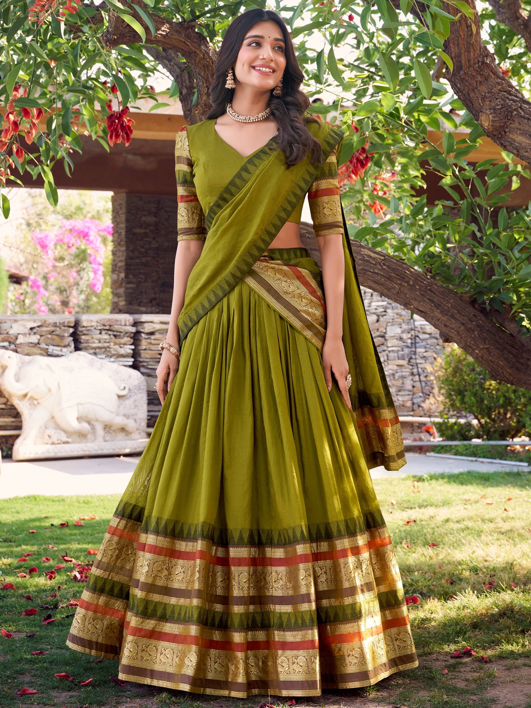 Olive green designer lehenga choli with gold and red border, perfect for Indian ethnic wear occasions.