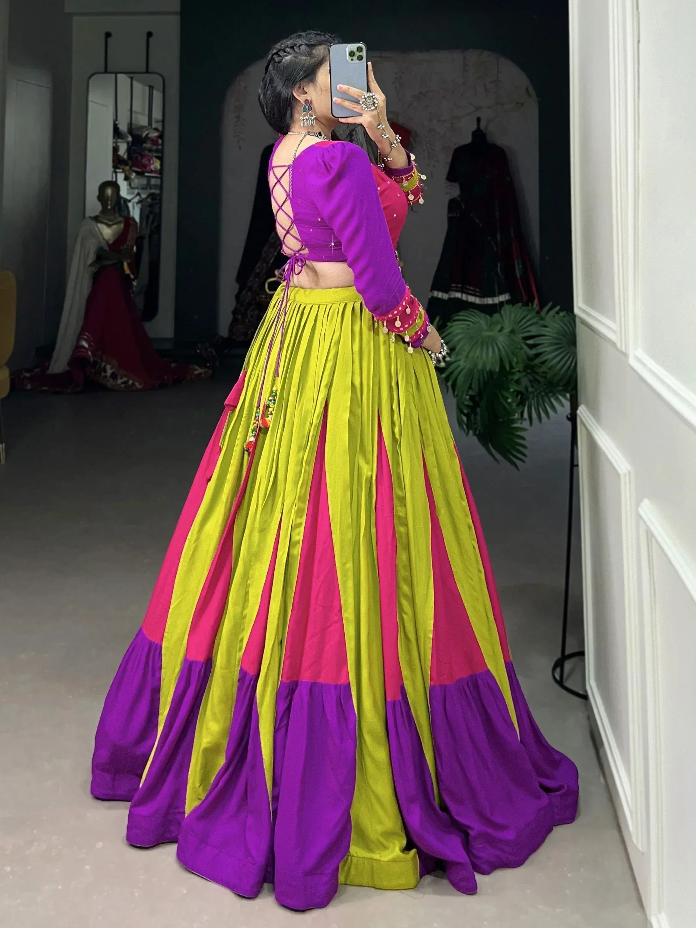 Vibrant purple and green Indian lehenga choli with crisscross back, perfect for festive occasions