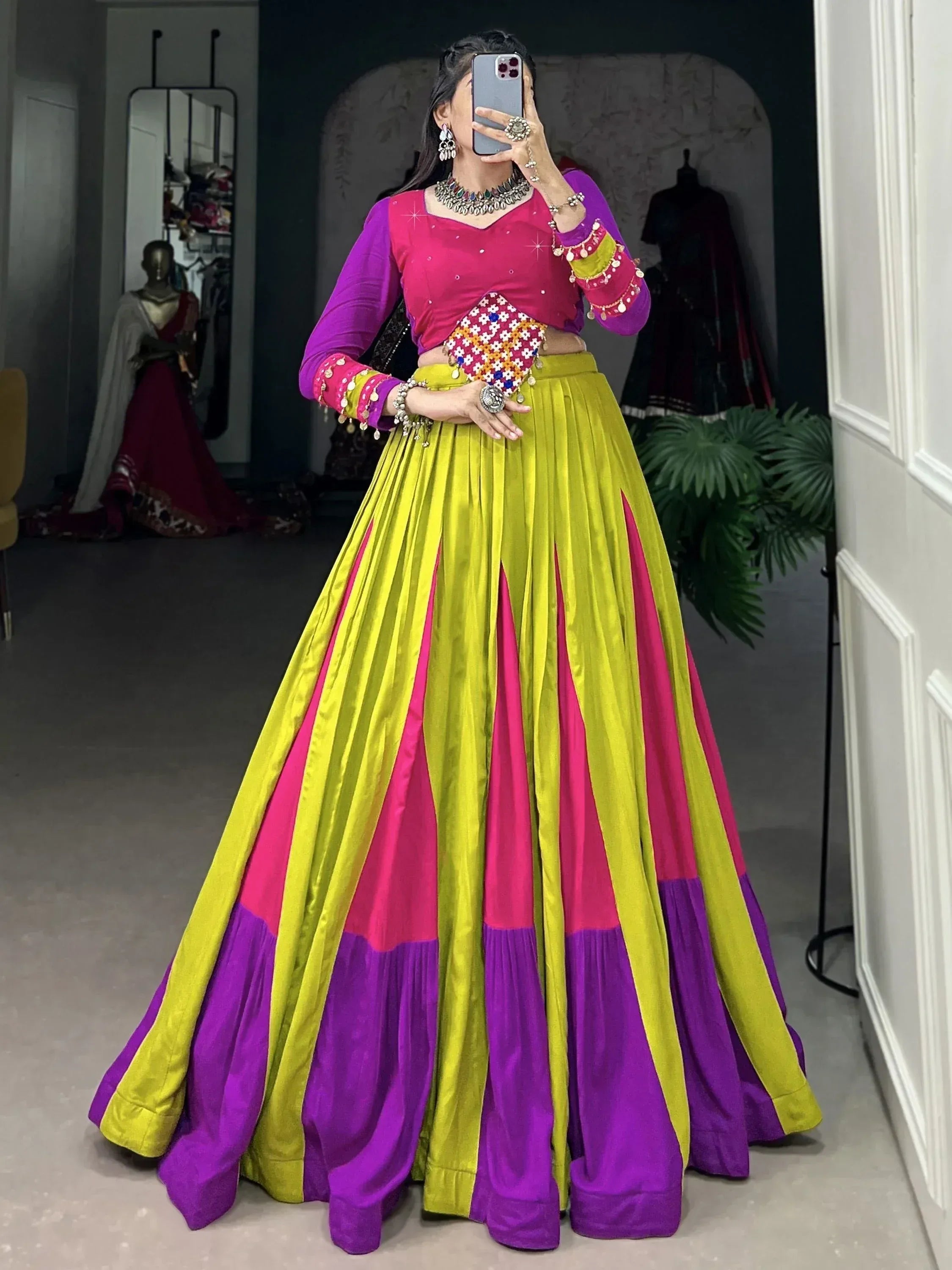 Vibrant Indian lehenga choli in pink, yellow, purple with mirror work, perfect for festive occasions