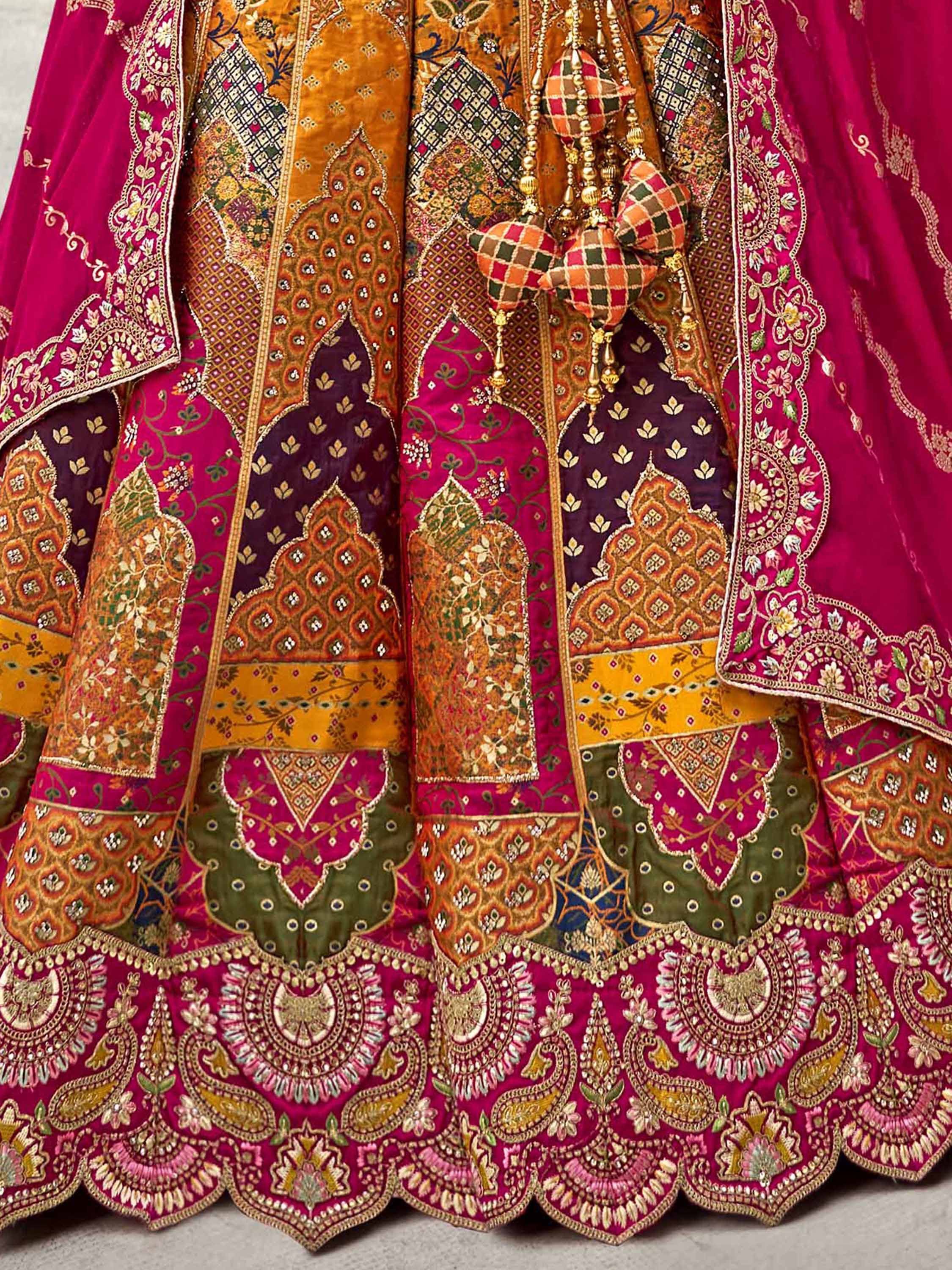 Luxury Indian lehenga choli with intricate embroidery, vibrant pink and gold patchwork, perfect for weddings and festivals.