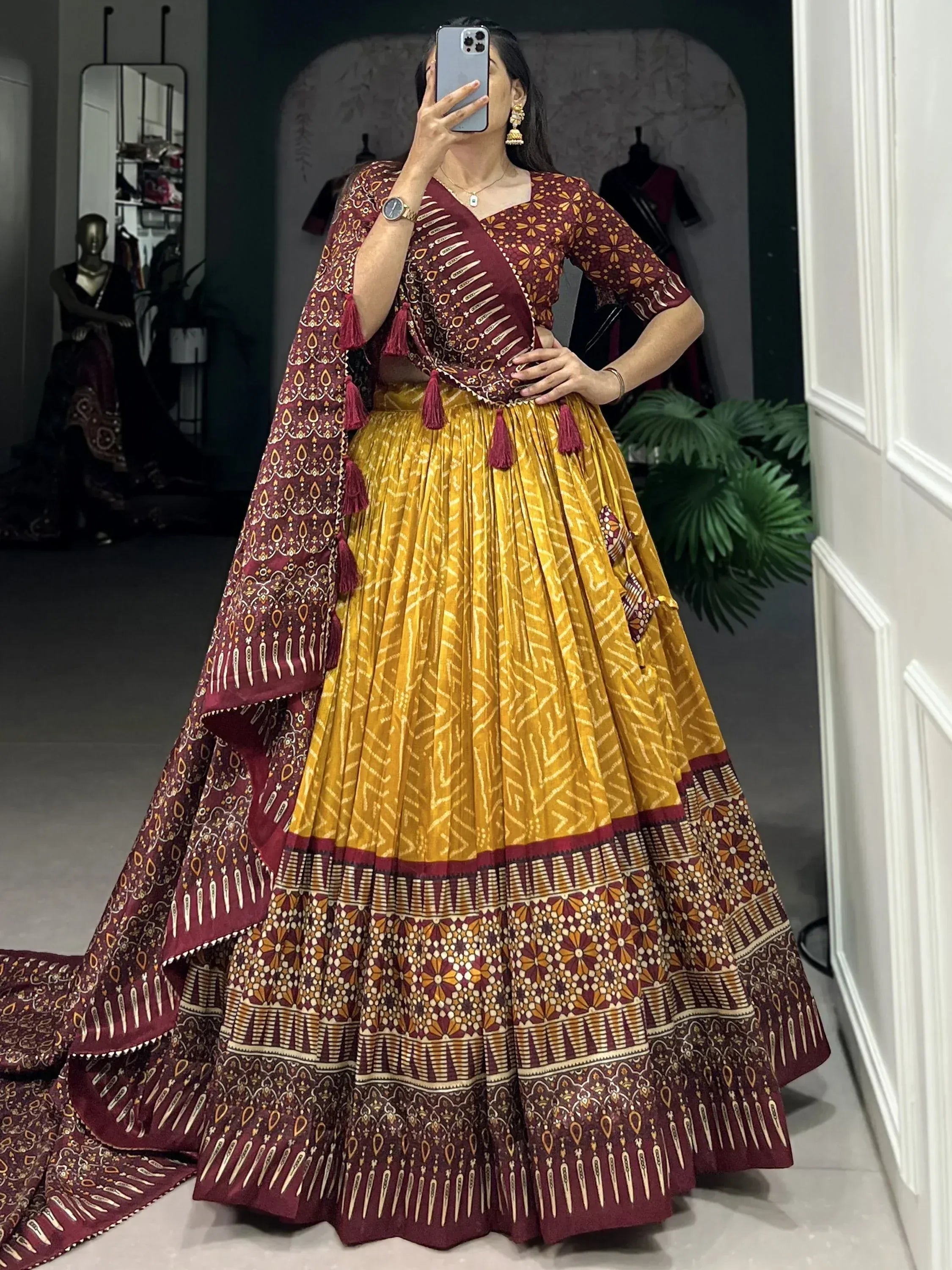 Maroon and yellow printed lehenga choli with tassels, perfect for Indian ethnic wear